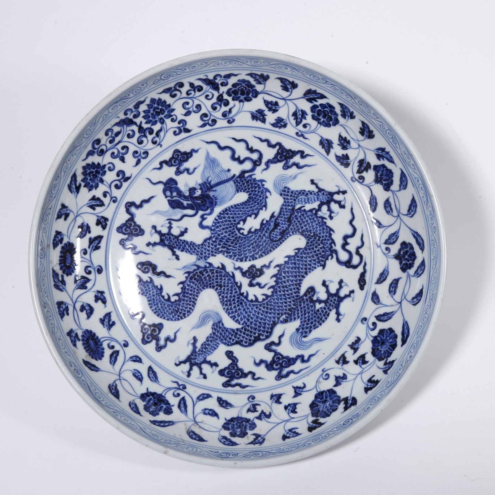 A BLUE AND WHITE PLATE WITH CLOUD AND DRAGON PATTERN (1 of 9)