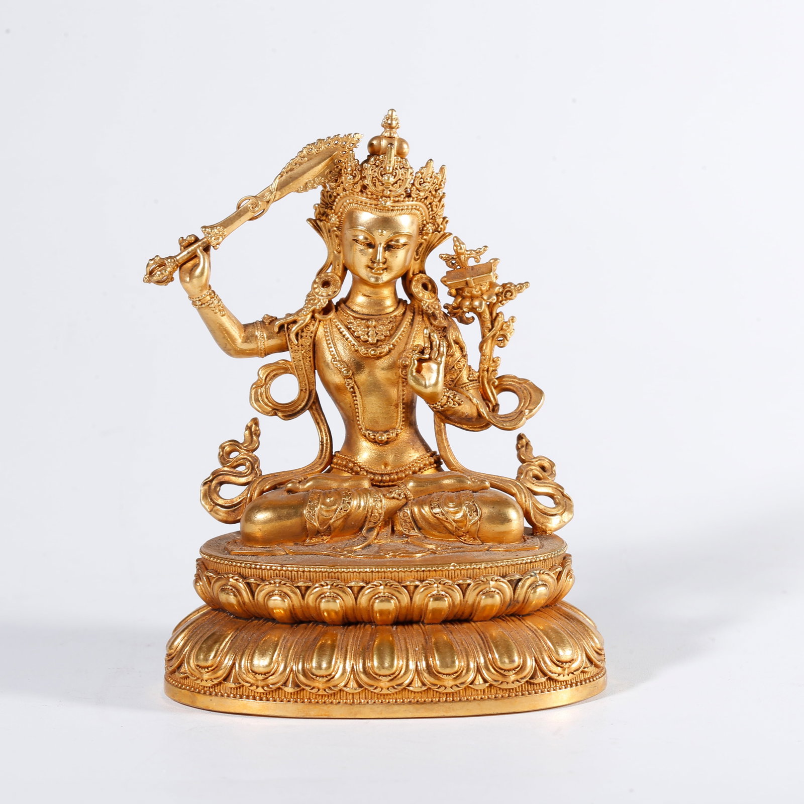 A GILT BRONZE STATUE OF SWORD-WIELDING MANJUSHRI: Gilt Bronze Statue of Sword-wielding Manjushri