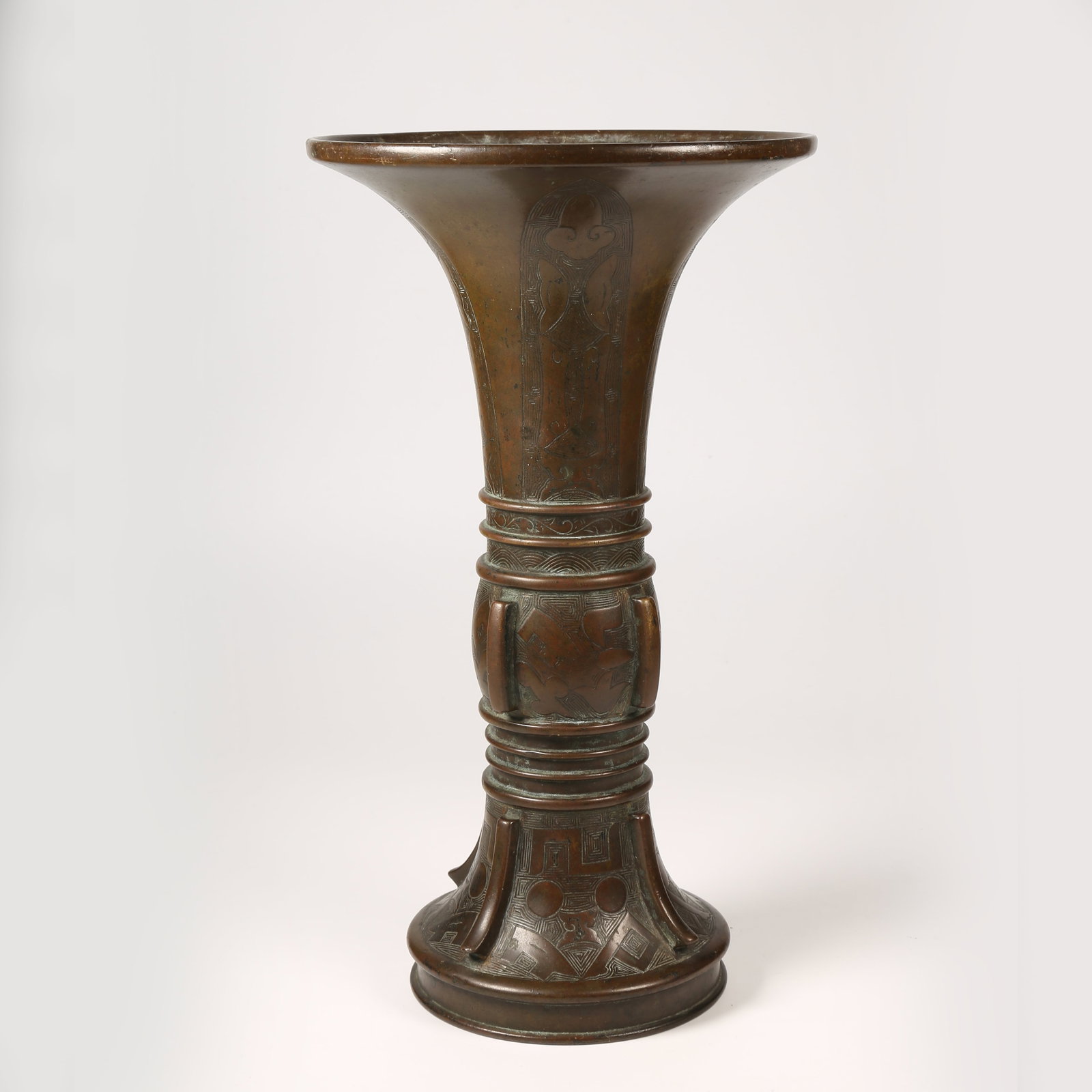 A BRONZE GU VESSEL WITH UPRIGHT FINIALS AND STRING PATTERN DECORATION (1 of 9)