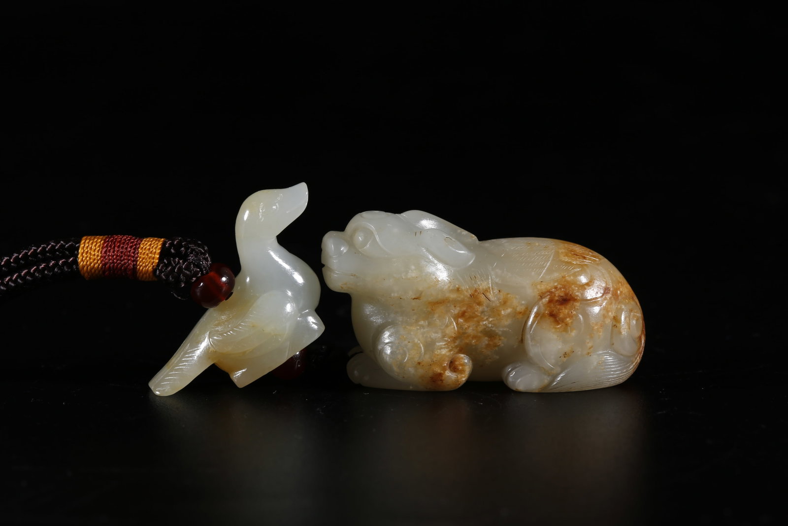 A HOTAN JADE CARVED BEAST-SHAPED PENDANT: Hotan Jade Carved Beast-shaped Pendant