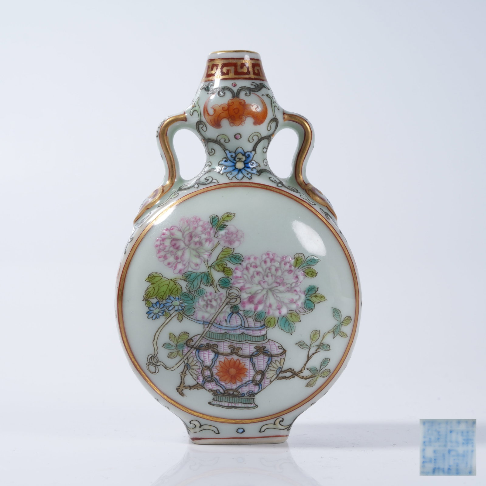 A FAMILLE ROSE RIBBON-EARED MOON FLASK WITH FLORAL PATTERN: Famille Rose Ribbon-eared Moon Flask with Floral Pattern
