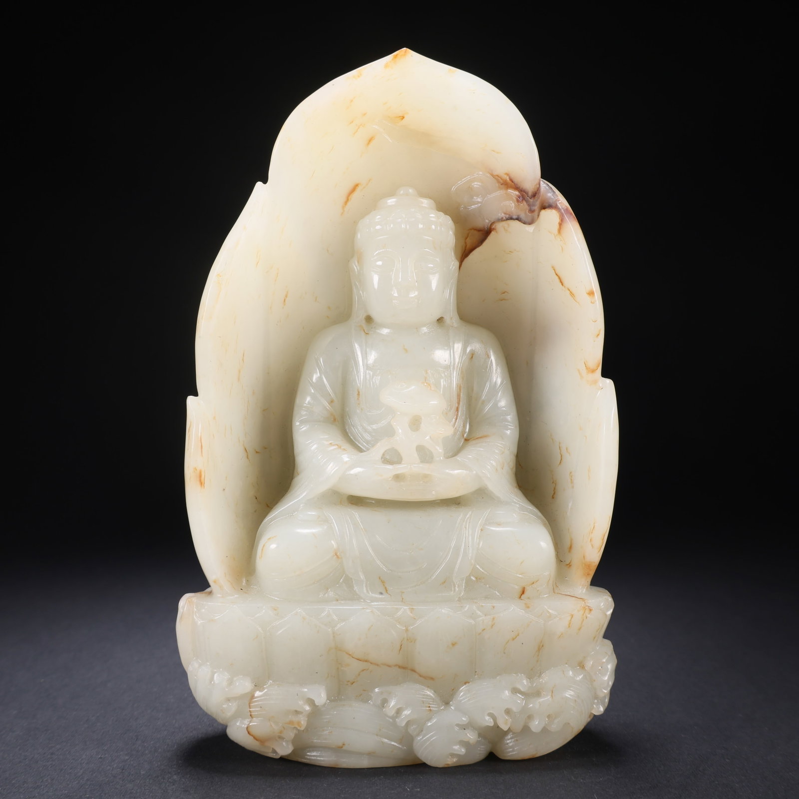 A HETIAN JADE SEATED BUDDHA WITH HALO: Hetian Jade Seated Buddha with Halo