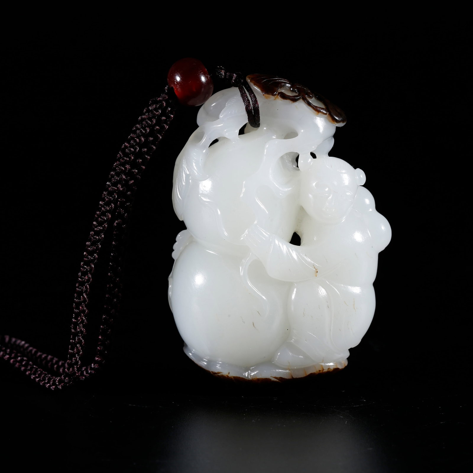 A HOTAN JADE CARVED CHILD AND GOURD-SHAPED HAND PIECE: Hotan Jade Carved Child and Gourd-shaped Hand Piece