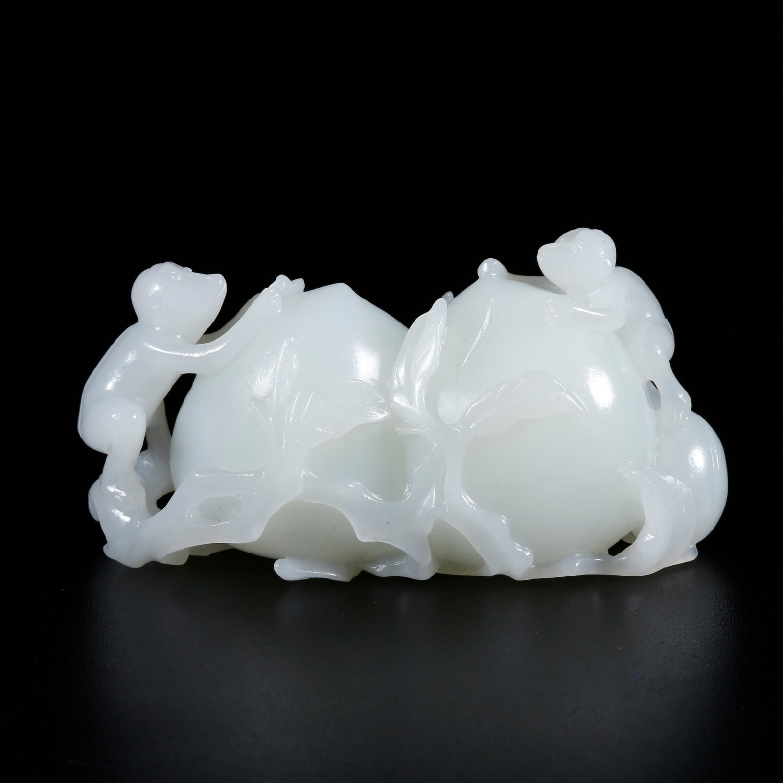 A HOTAN JADE CARVED PEACH AND MONKEY-SHAPED ORNAMENT (1 of 9)