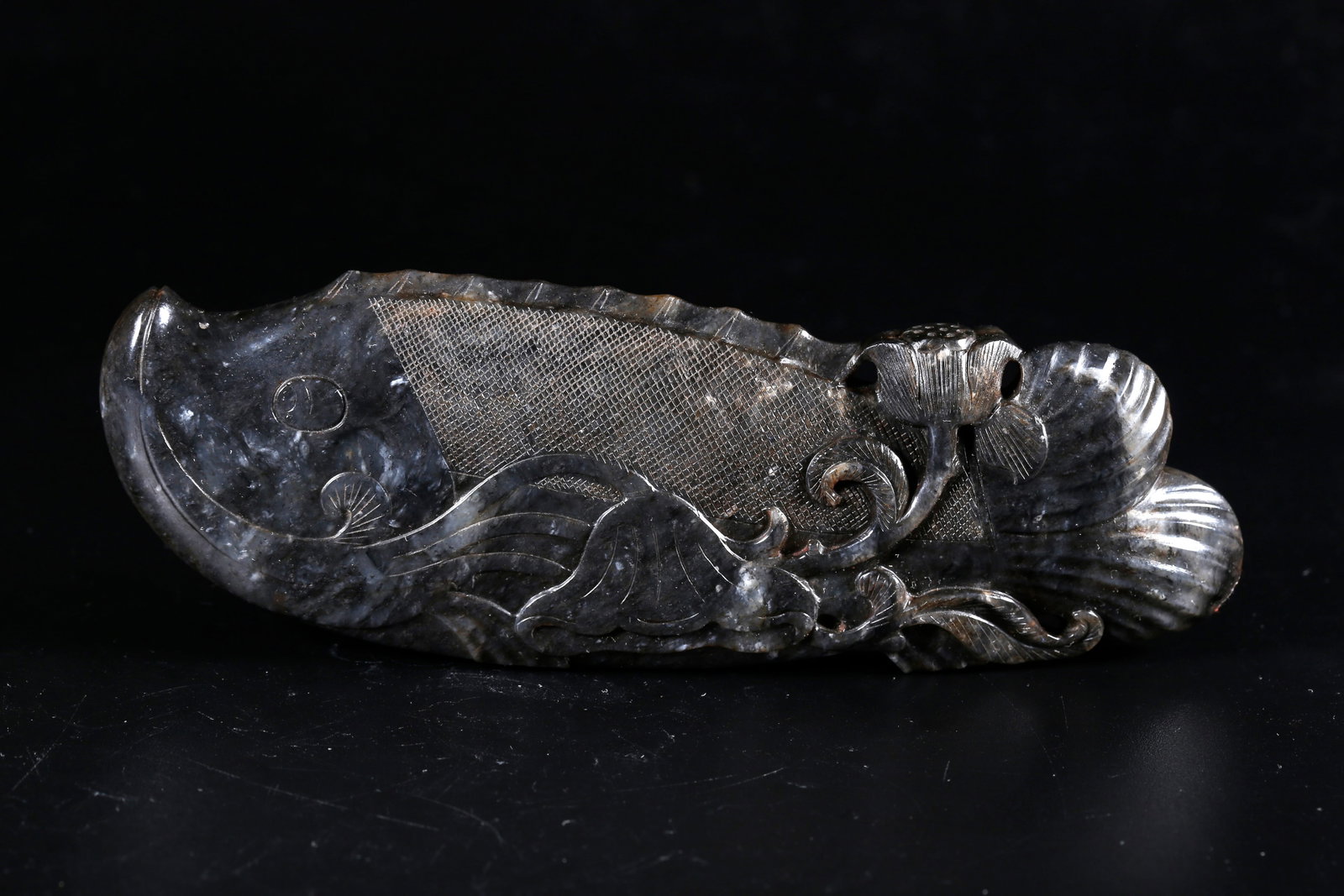 A HOTAN JADE CARVED FISH-SHAPED ORNAMENT: Hotan Jade Carved Fish-shaped Ornament