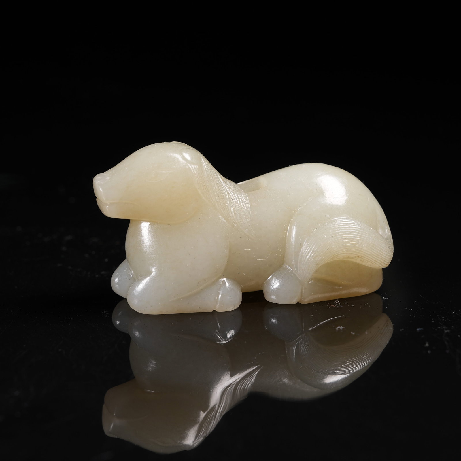 A HETIAN JADE RECUMBENT BEAST PENDANT (1 of 8)