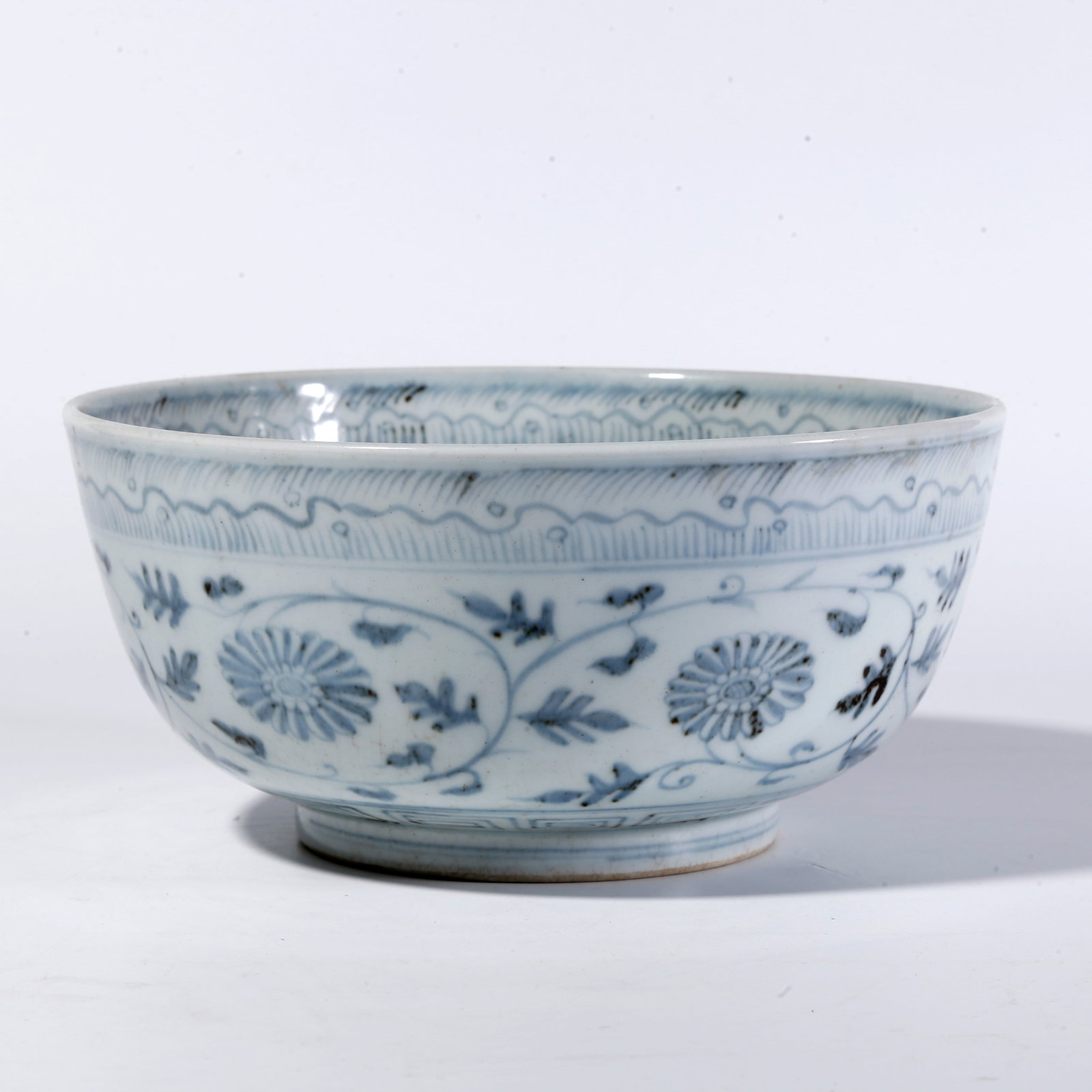 A BLUE-AND-WHITE FLORAL SCROLL BOWL: Blue-and-White Floral Scroll Bowl