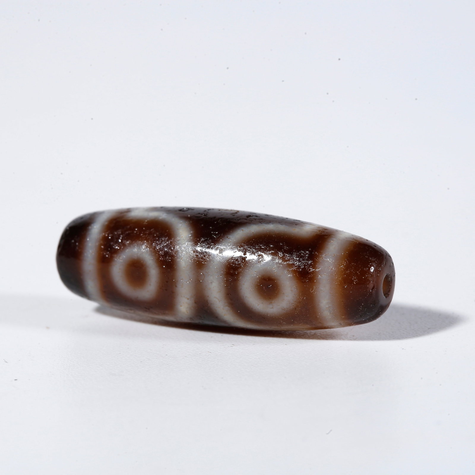 A THREE-EYED DZI BEAD (1 of 9)