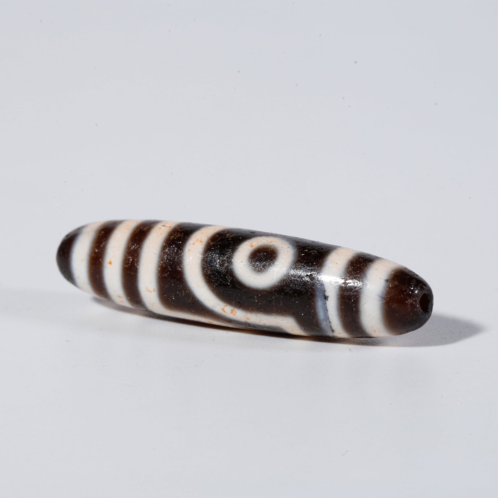 A TWO-EYED DZI BEAD (1 of 9)