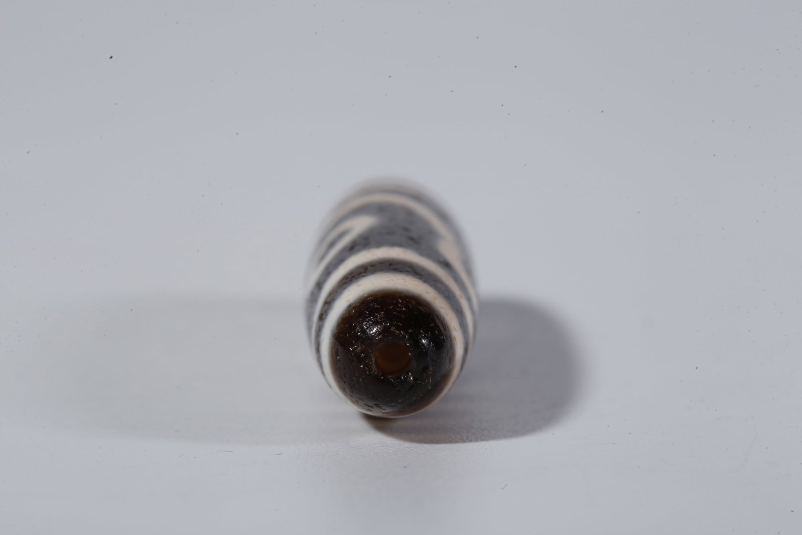 A TWO-EYED DZI BEAD - 9