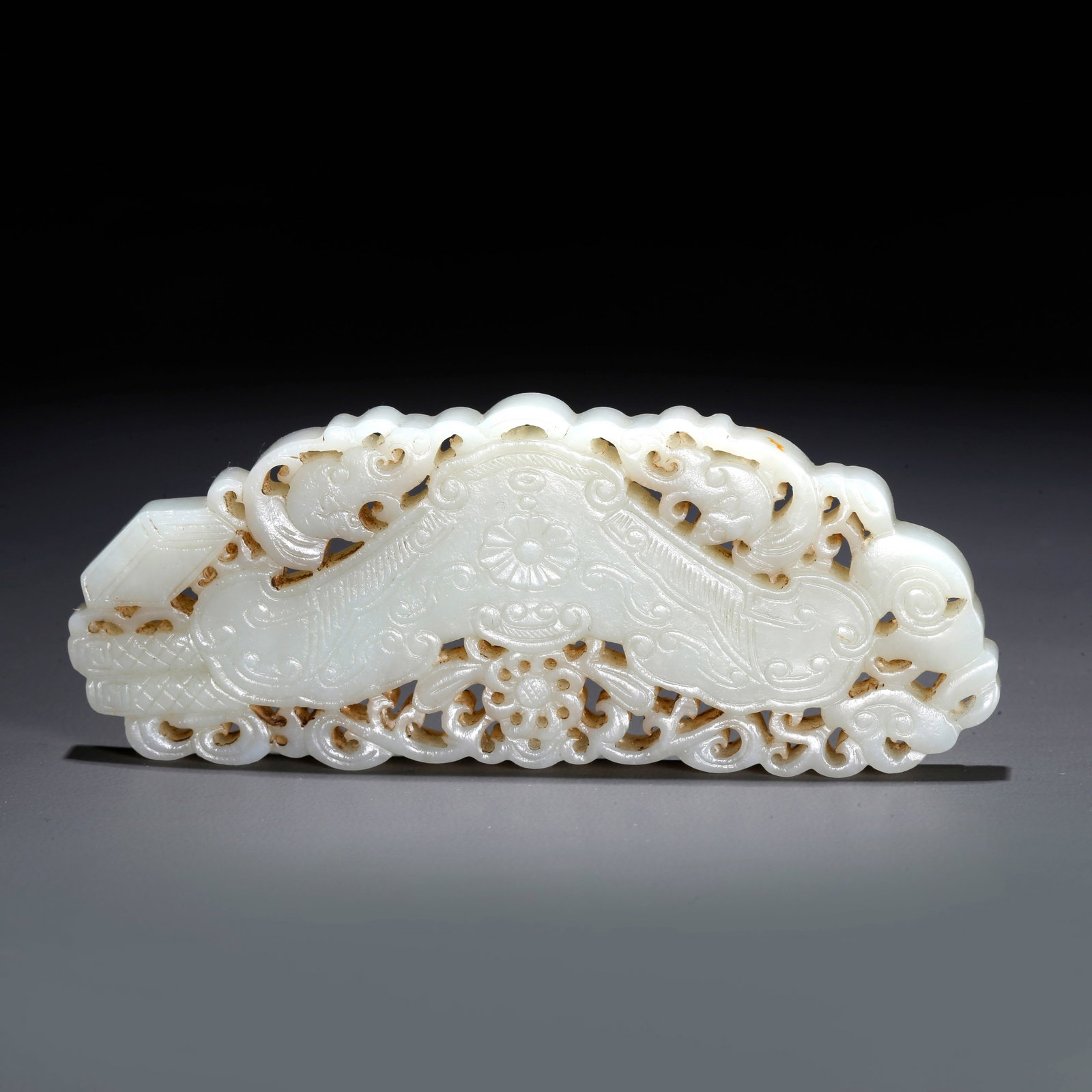 A CARVED HETIAN JADE PENDANT WITH FLORAL PATTERN: Carved Hetian Jade Pendant with Floral Pattern
