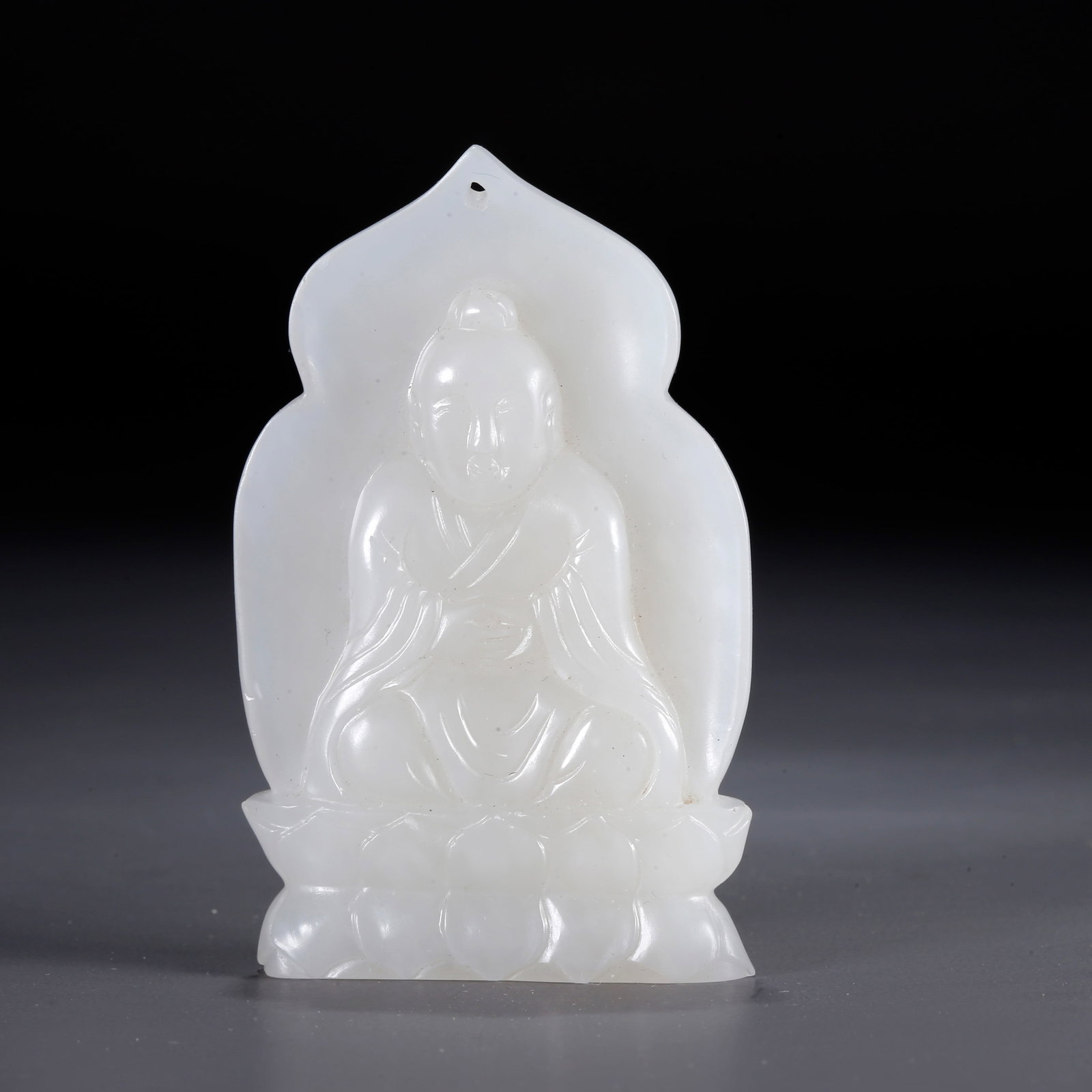 A CARVED HETIAN JADE PENDANT WITH BUDDHA PATTERN: Carved Hetian Jade Pendant with Buddha Pattern
