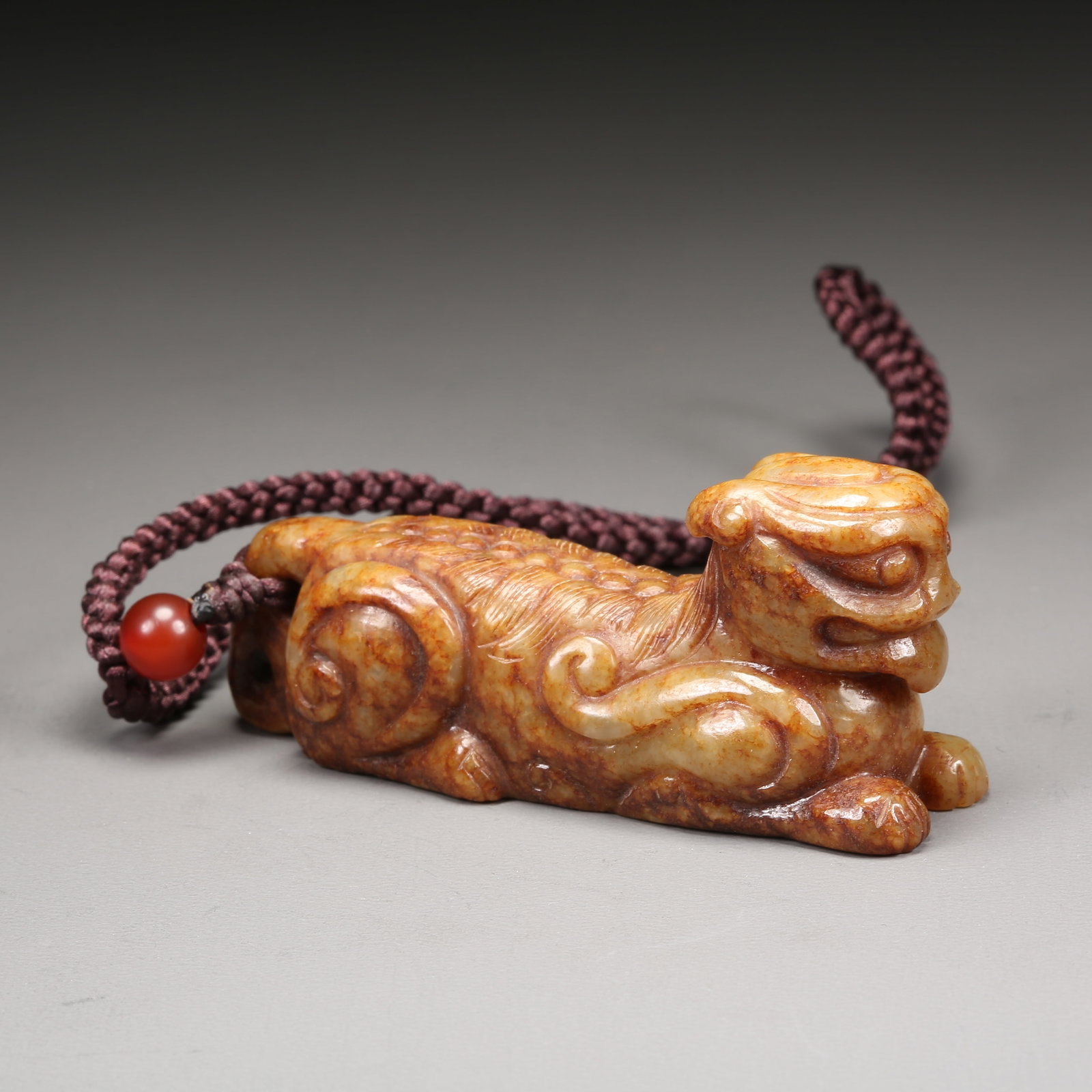 A HETIAN JADE AUSPICIOUS BEAST HANDLE (1 of 9)