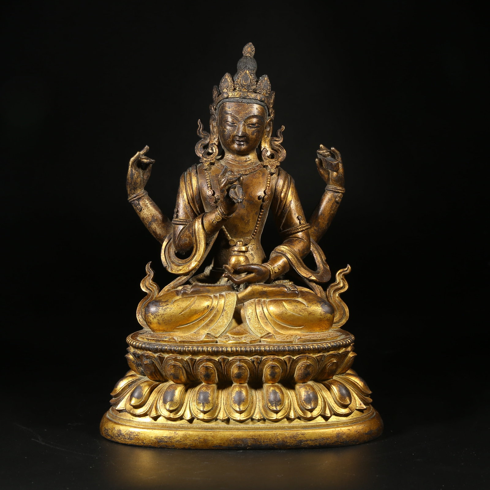 A GILT-BRONZE STATUE OF FOUR-ARMED MOTHER BUDDHA (1 of 8)
