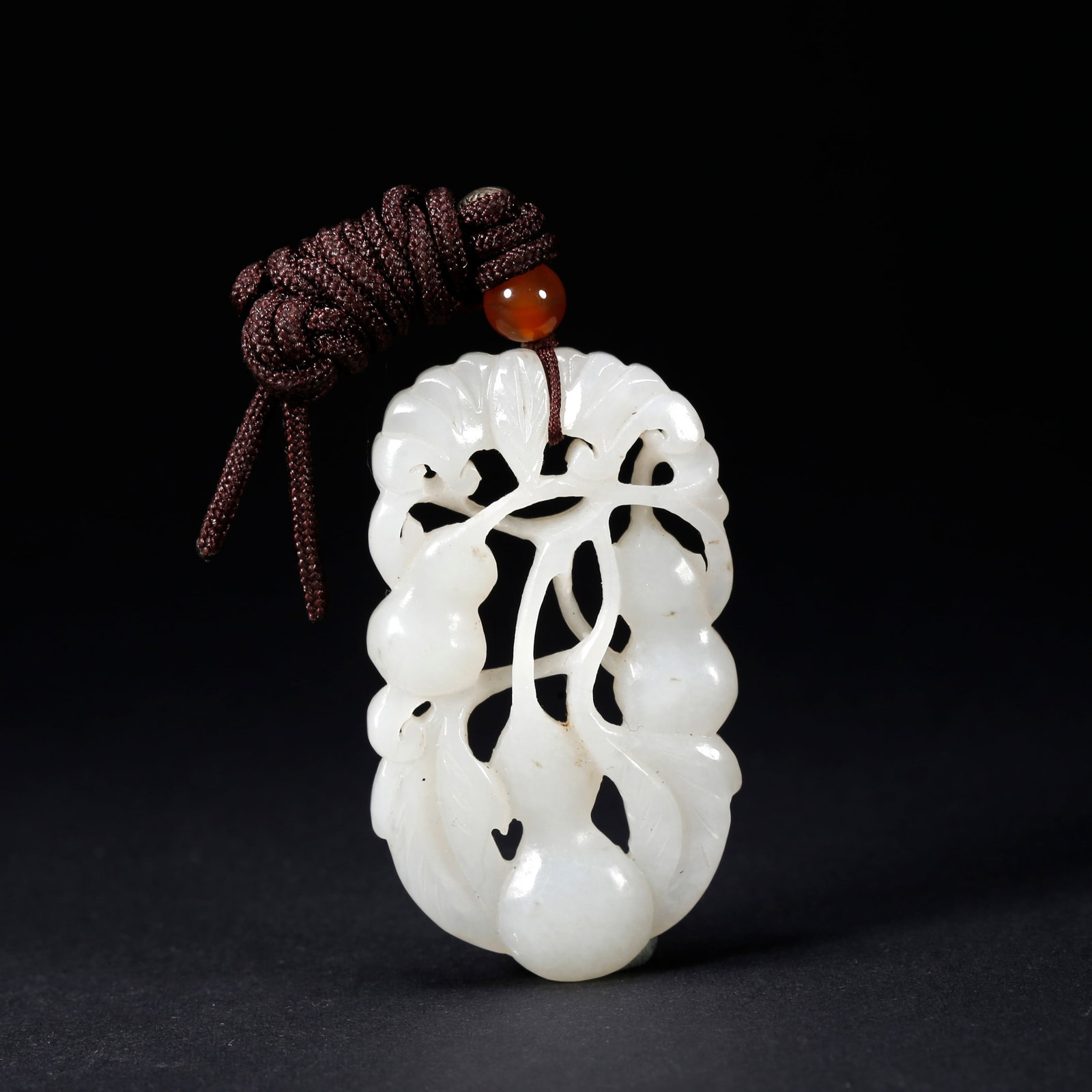 A HETIAN JADE GOURD-SHAPED PENDANT: Hetian Jade Gourd-Shaped Pendant