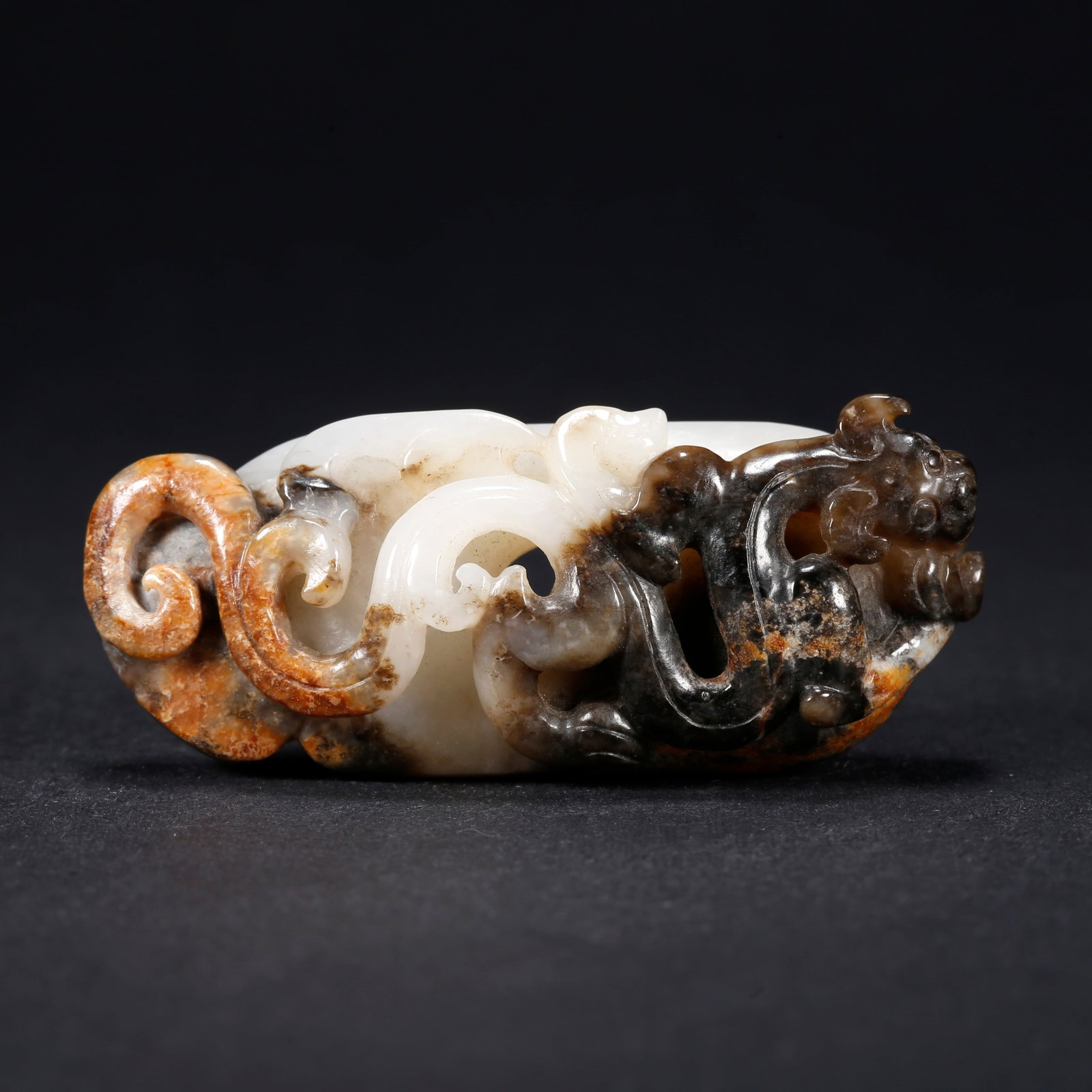 A HETIAN JADE CHICKEN-HEART PENDANT WITH CHI-DRAGON MOTIF (1 of 9)