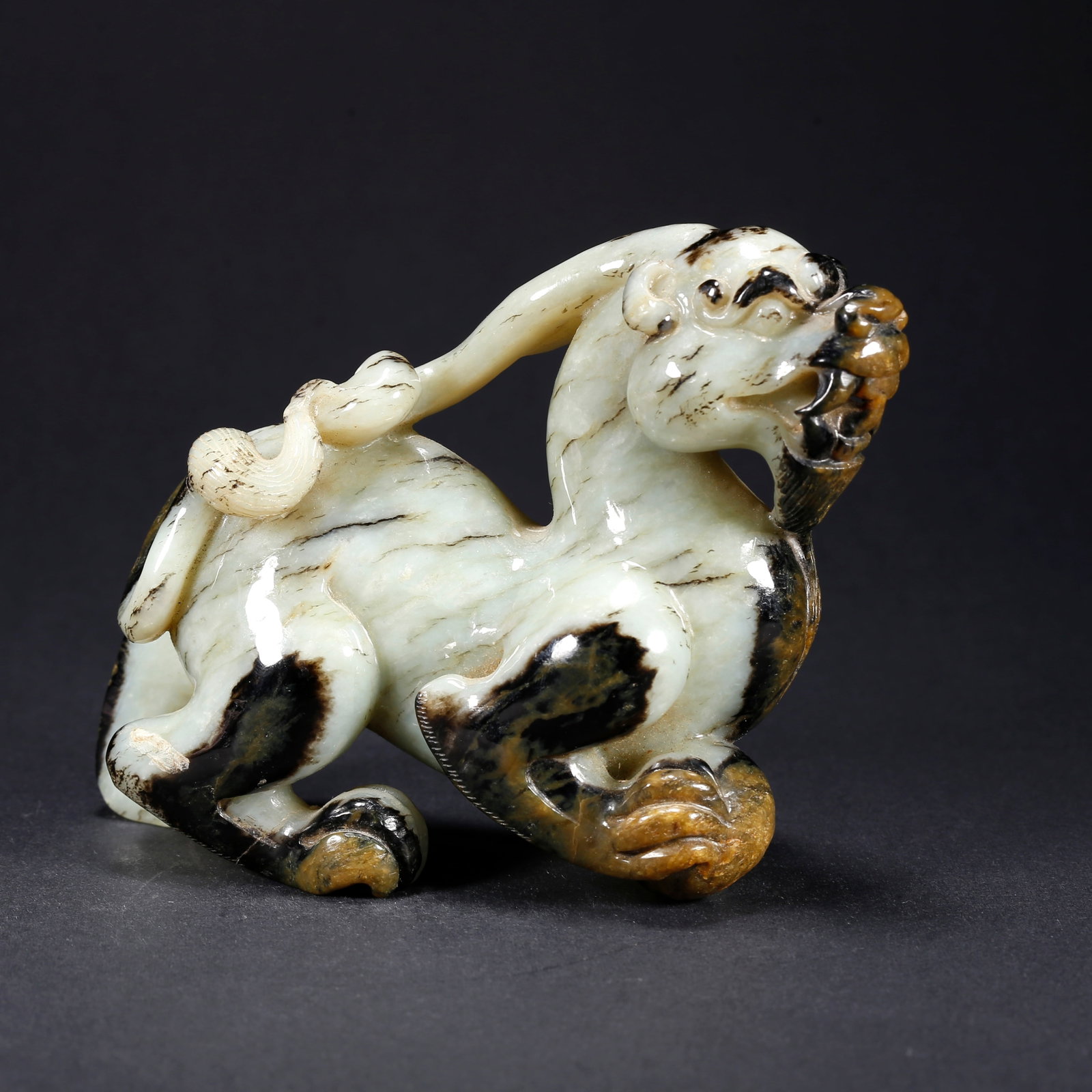 A HETIAN JADE TIGER-SHAPED FIGURINE (1 of 9)