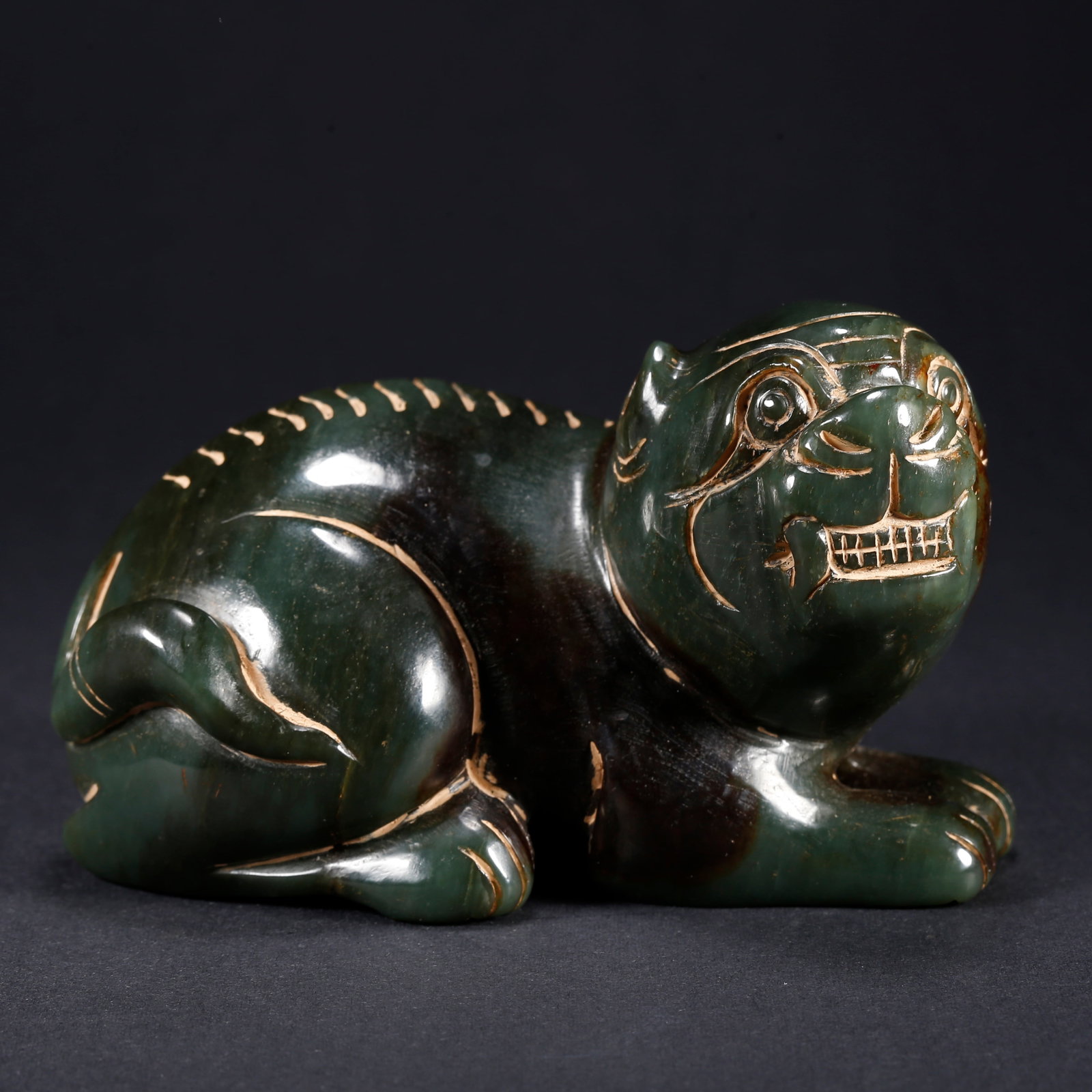 A HETIAN BIYU BEAST-SHAPED FIGURINE (1 of 10)