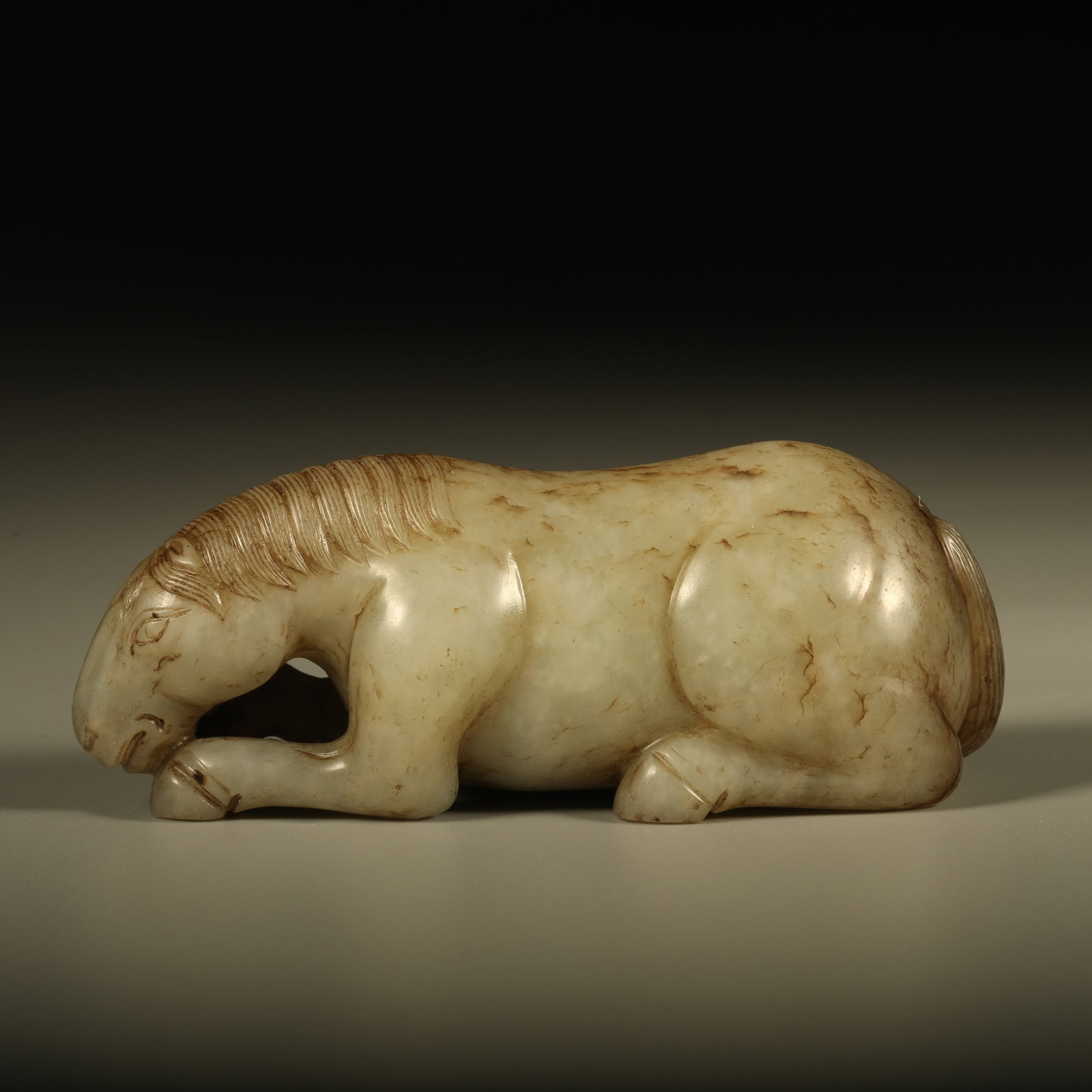 A HETIAN JADE HAND PIECE CARVED WITH RECLINING HORSE (1 of 6)