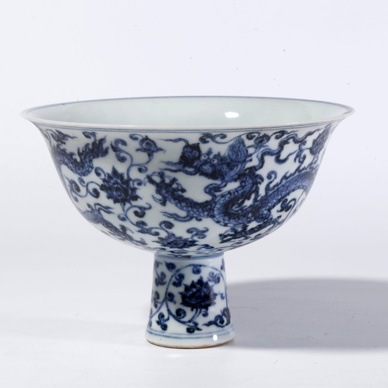 A BLUE-AND-WHITE DRAGON THROUGH FLOWERS HIGH-FOOT BOWL: Blue-and-White Dragon Through Flowers High-Foot Bowl