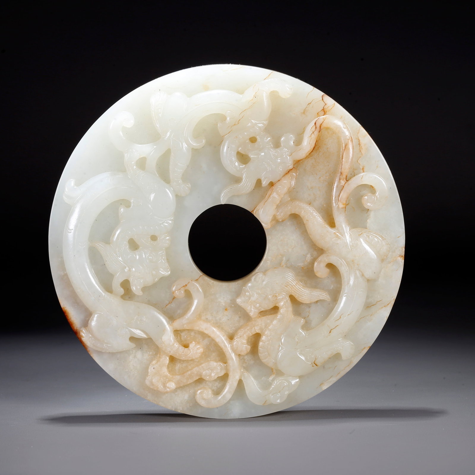 A CARVED HETIAN JADE BI DISC WITH DRAGON PATTERN (1 of 10)