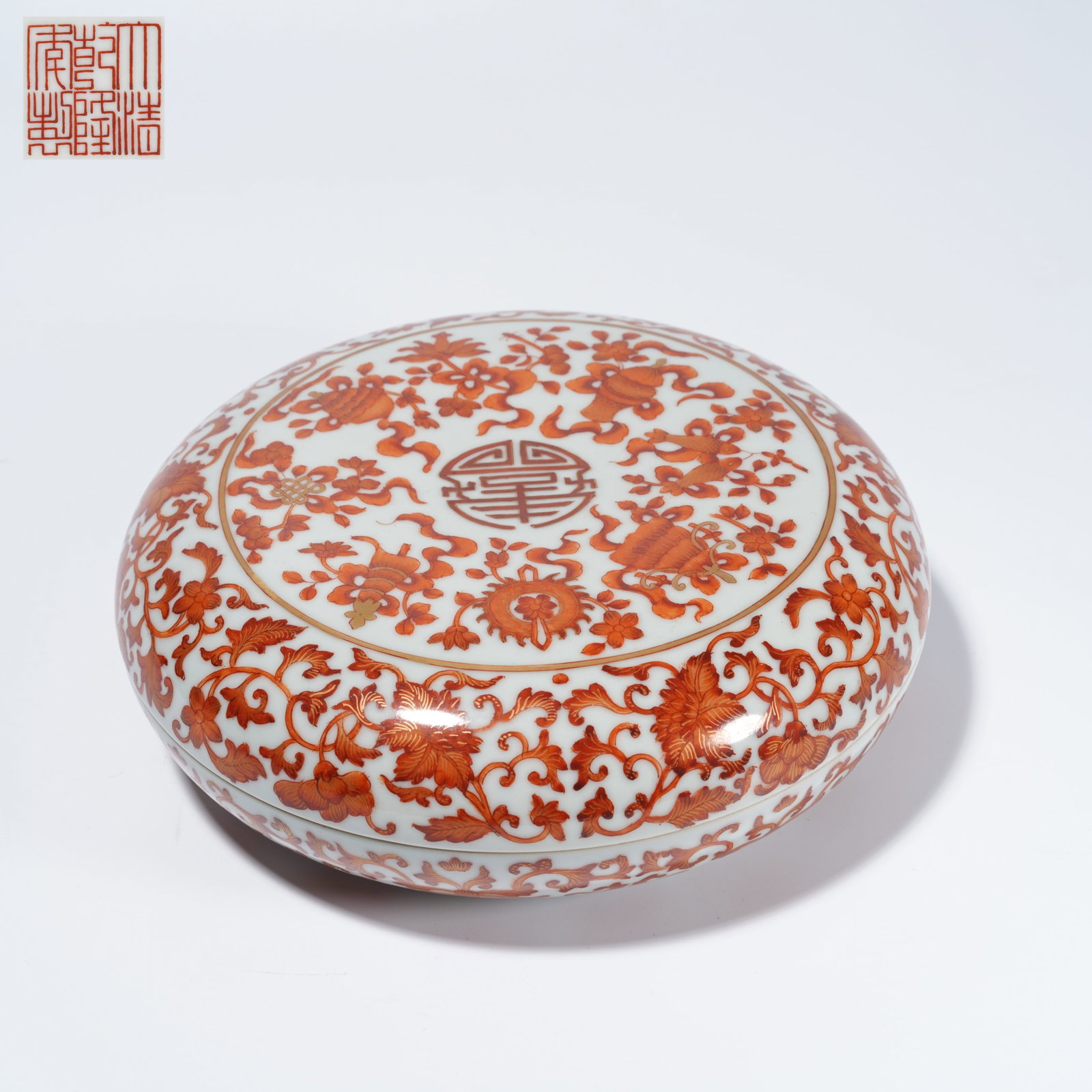 A UNDERGLAZE-RED COVERED BOX WITH EIGHT TREASURES MOTIF: Underglaze-Red Covered Box with Eight Treasures Motif