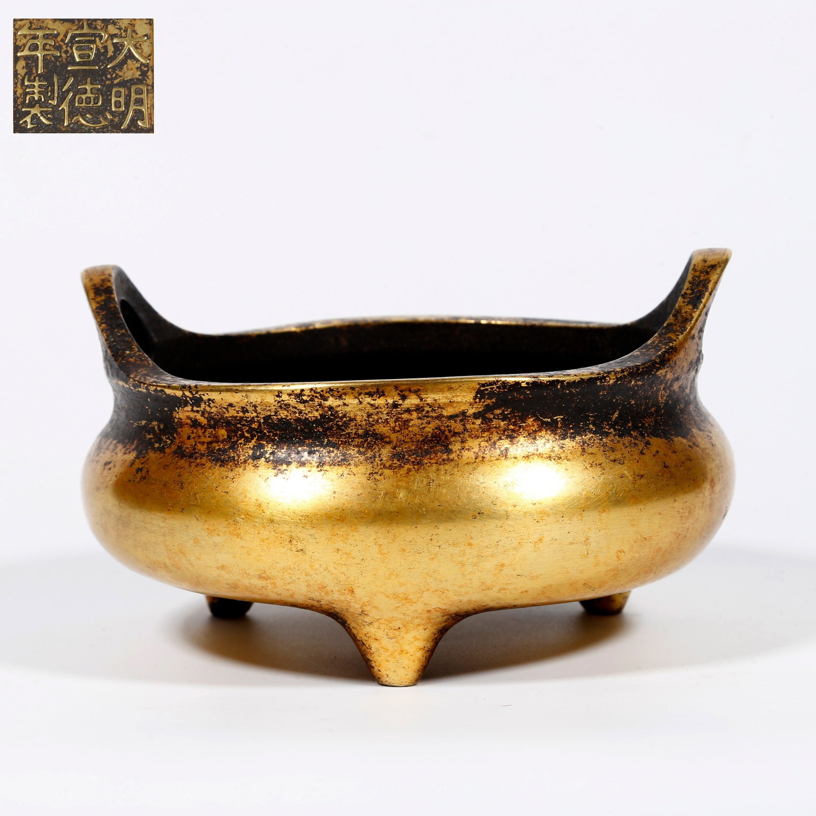 A GILT-BRONZE THREE-LEGGED CENSER: Gilt-bronze three-legged censer
