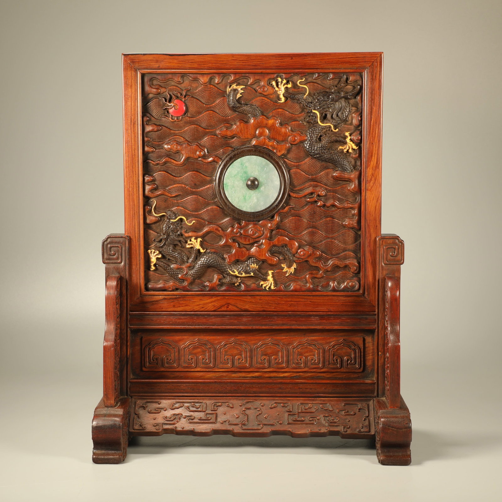 A HUANGHUALI TABLE SCREEN INLAID WITH JADE DISC AND RED SANDALWOOD CARVED DOUBLE DRAGONS PLAYING: Huanghuali Table Screen Inlaid with Jade Disc and Red Sandalwood Carved Double Dragons Playing Pearl