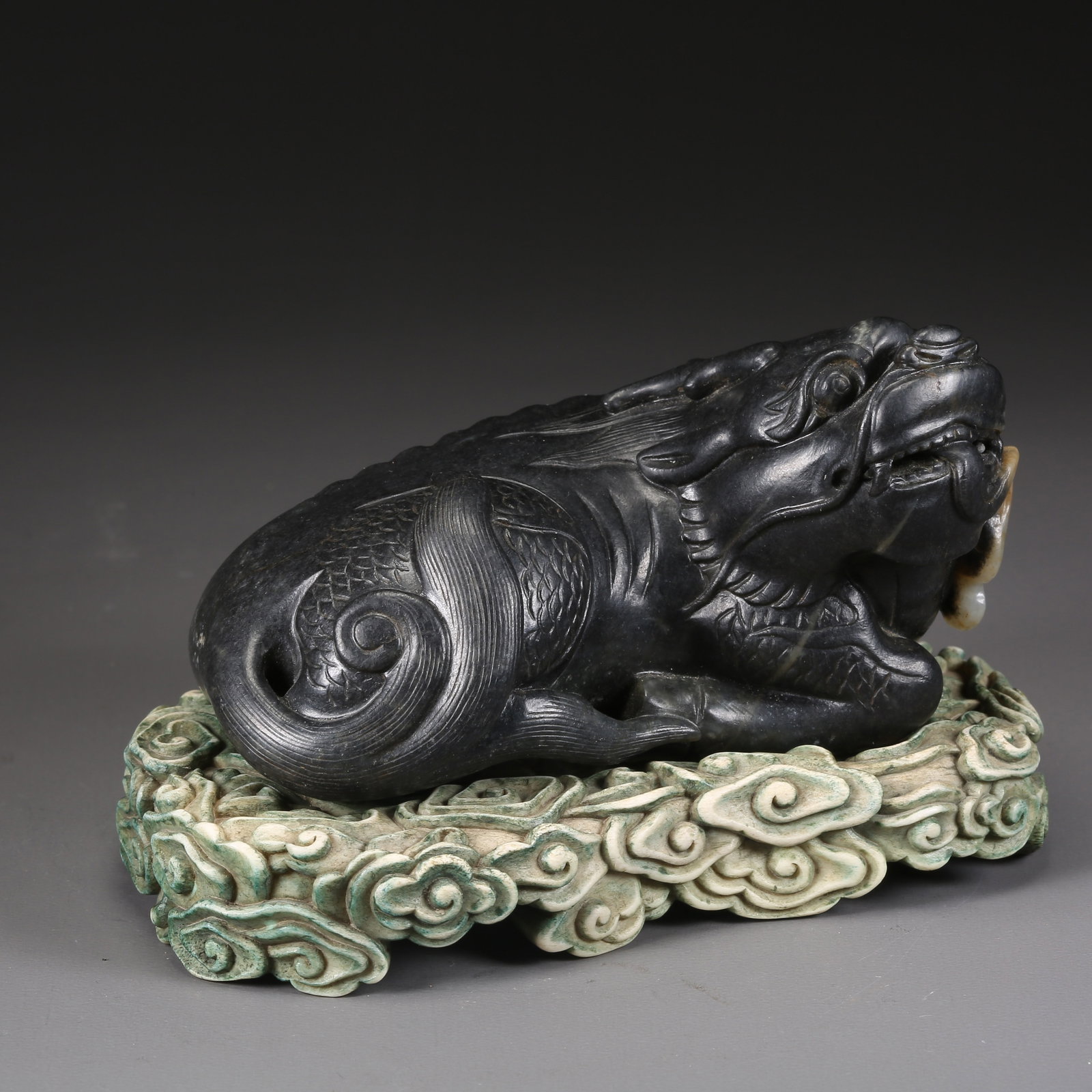 A HETIAN JADE INTRICATELY CARVED QILIN ORNAMENT: Hetian jade intricately carved Qilin ornament