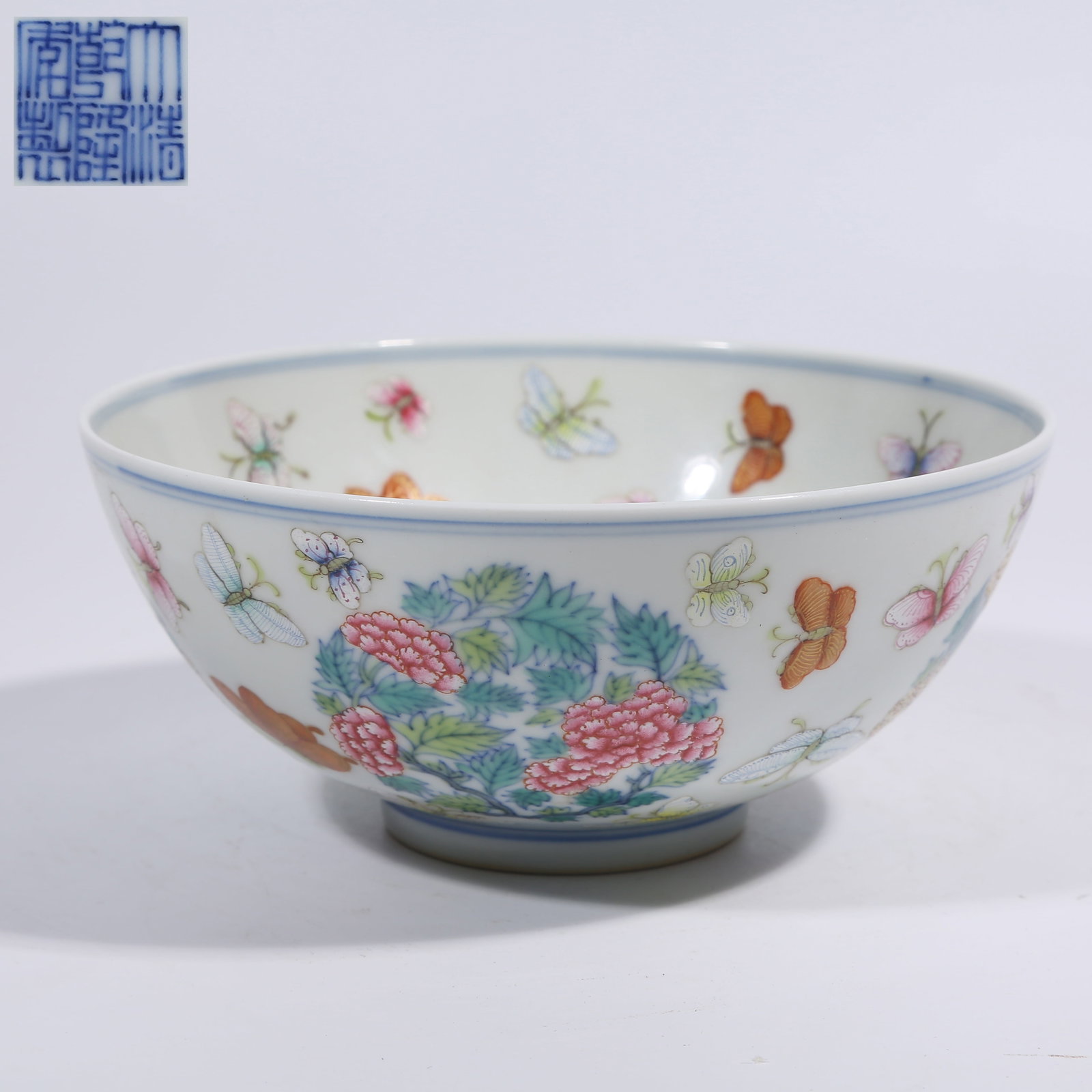 A FAMILLE ROSE BOWL WITH FLOWER AND BUTTERFLY PATTERN: Famille Rose Bowl with Flower and Butterfly Pattern