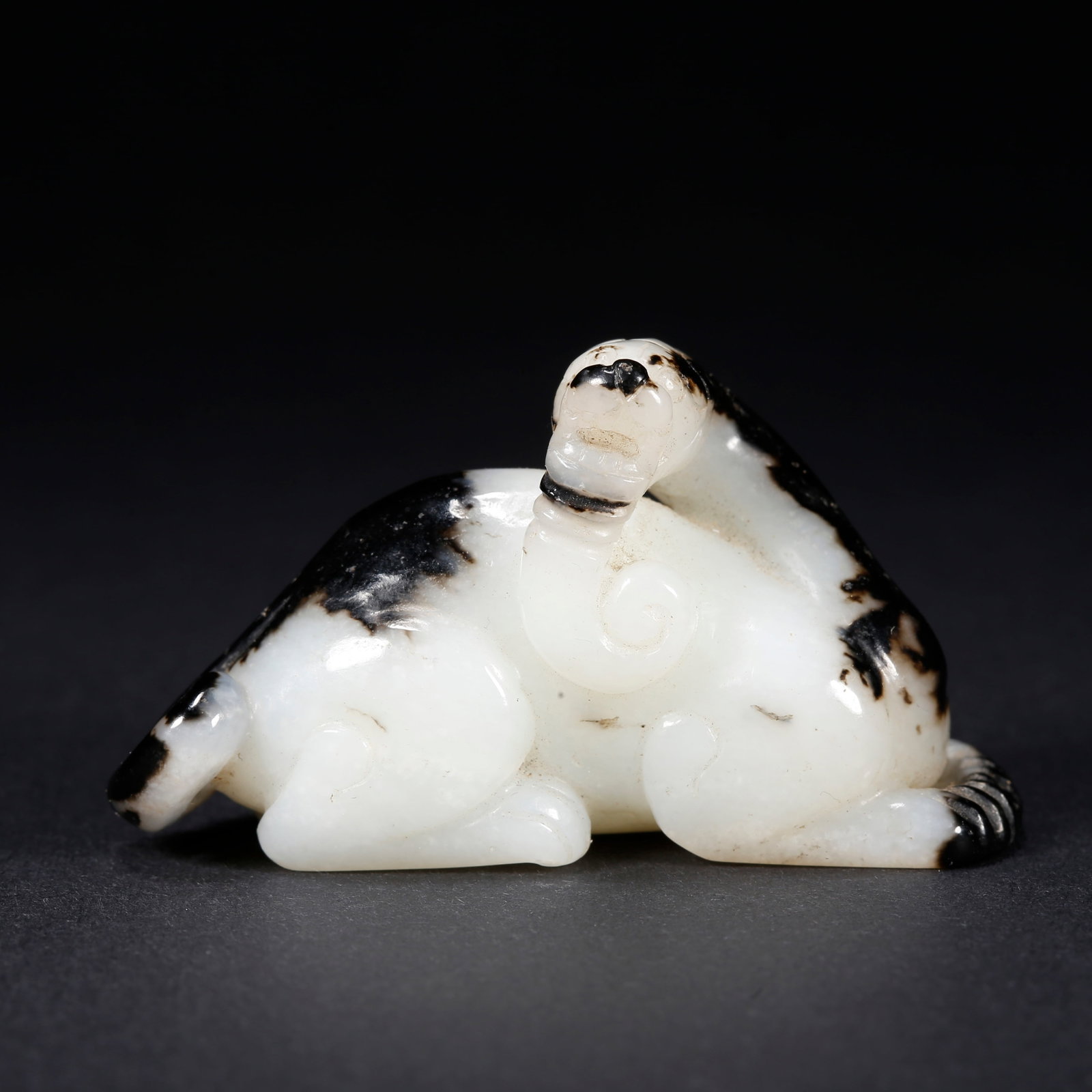 A HETIAN JADE BEAST-SHAPED FIGURINE (1 of 9)