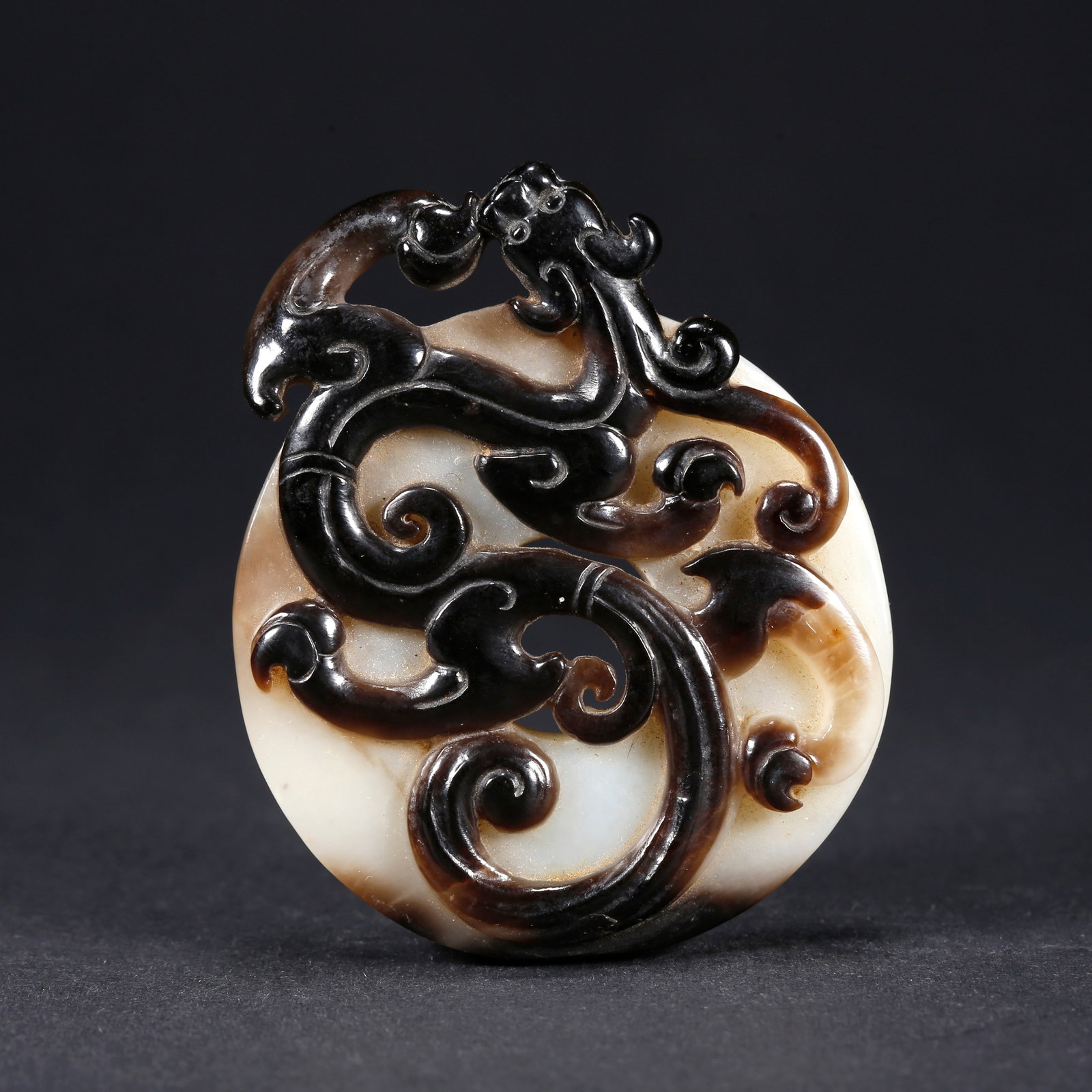 A HETIAN JADE BI DISC WITH DRAGON MOTIF: Hetian Jade Bi Disc with Dragon Motif