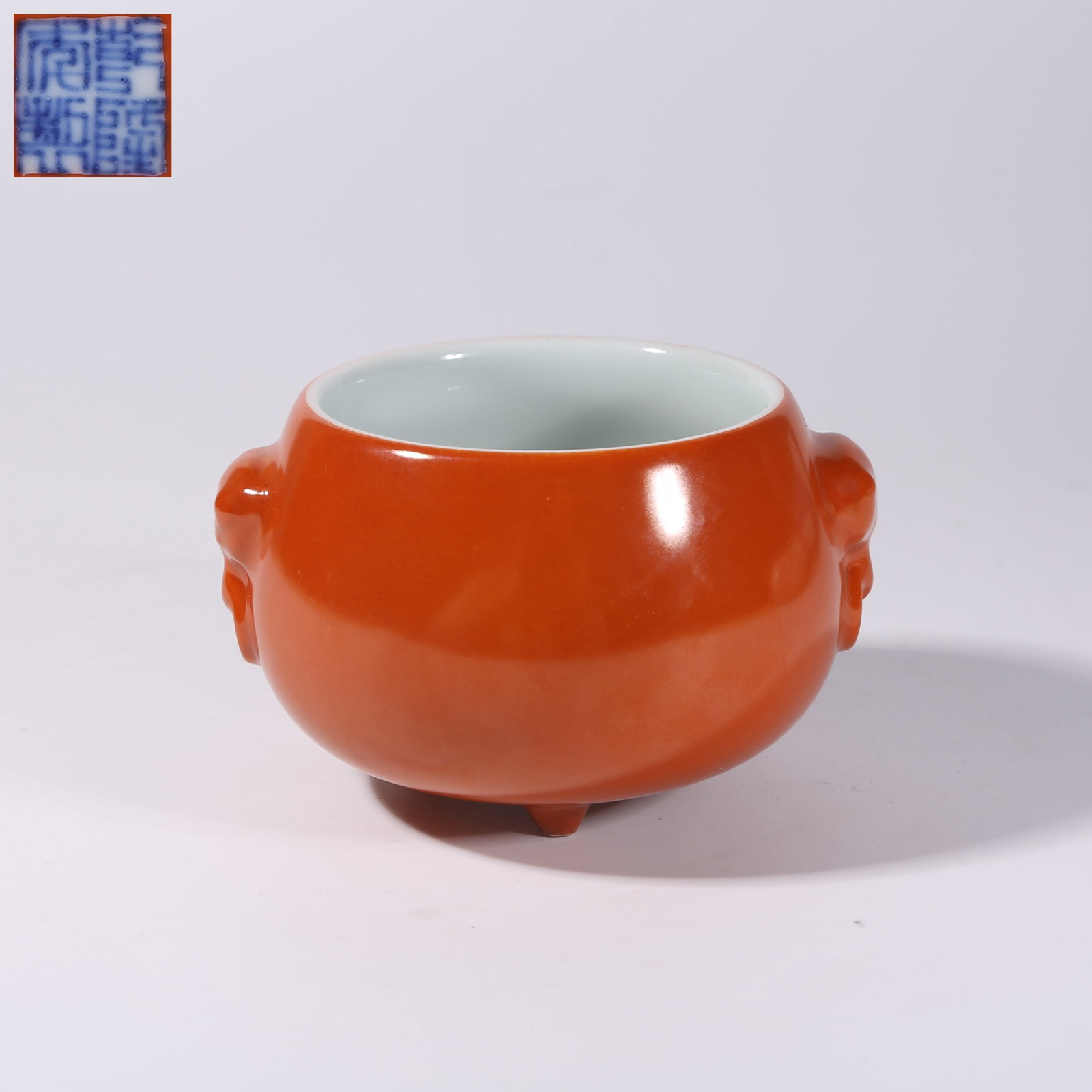 A PEA-RED GLAZE TRIPOD BEAST-HANDLED CENSER: Pea-Red Glaze Tripod Beast-Handled Censer