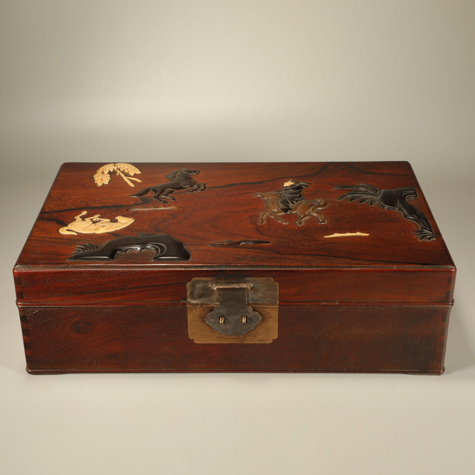 A HUANGHUALI BOX INLAID WITH RED SANDALWOOD CARVED HERDING FIGURES: Huanghuali Box Inlaid with Red Sandalwood Carved Herding Figures