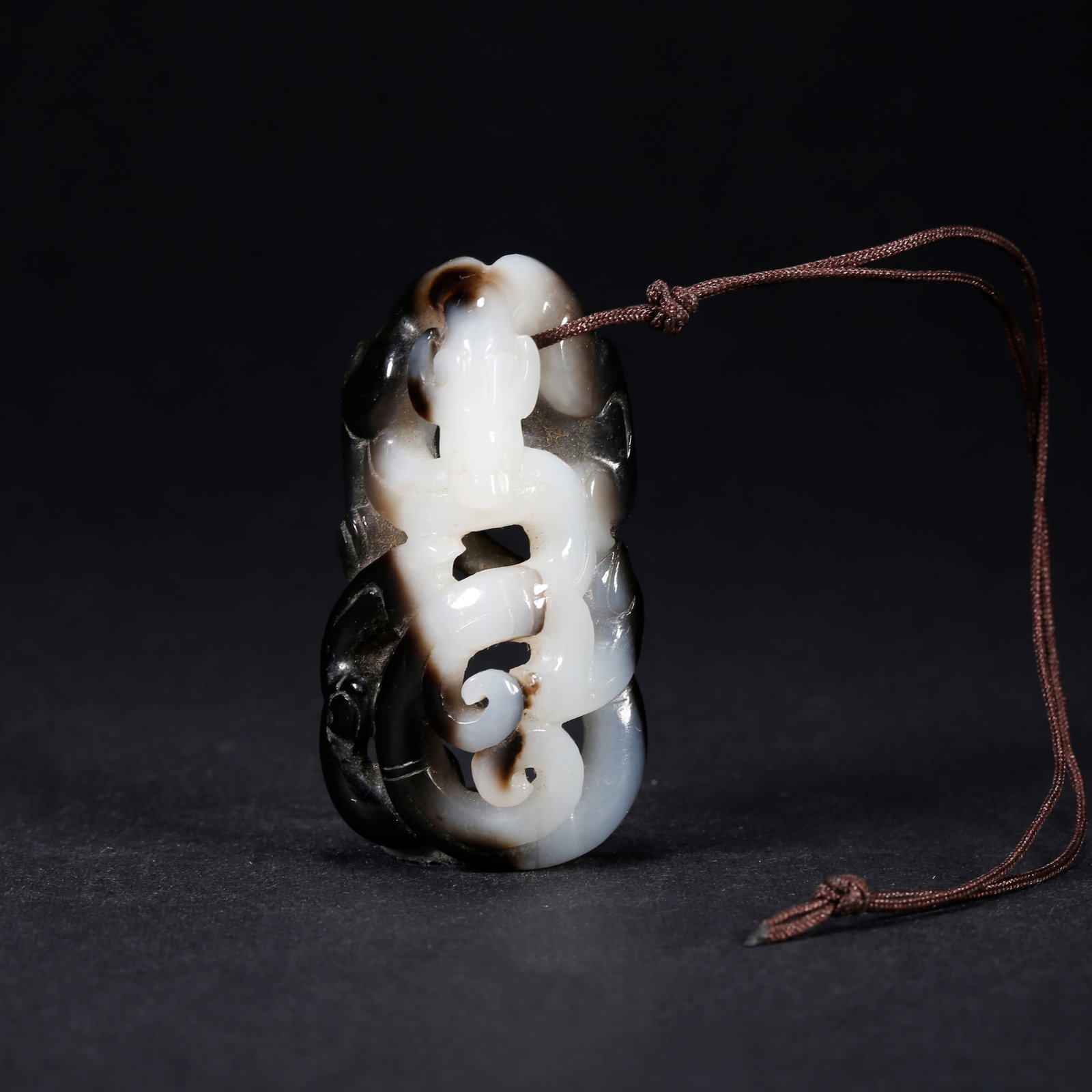 A HETIAN JADE HANDLE WITH CHI-DRAGON MOTIF: Hetian Jade Handle with Chi-Dragon Motif