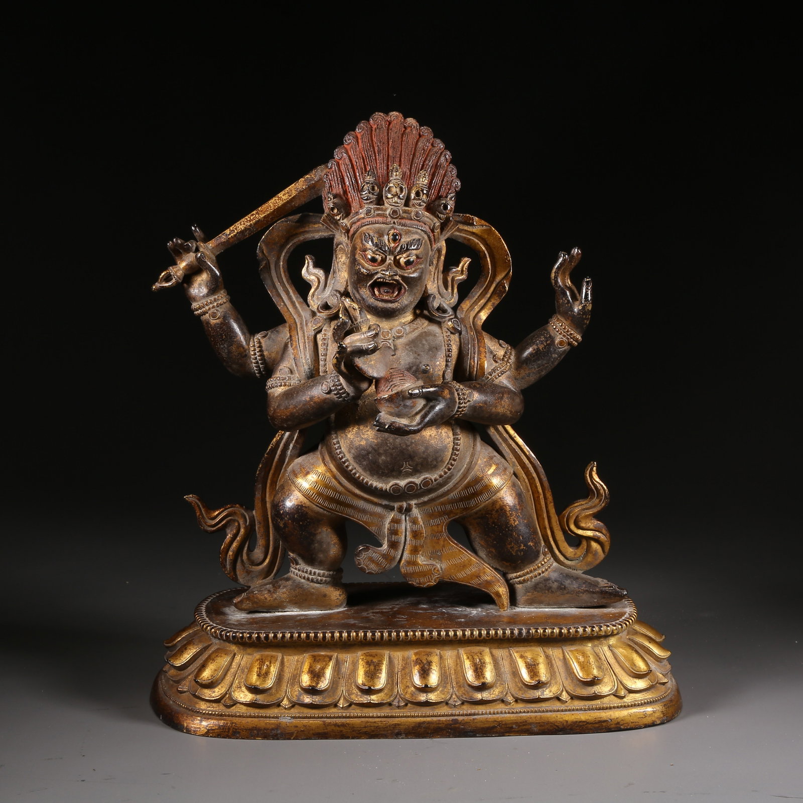 A GILT-BRONZE STATUE OF THE FOUR-ARMED MAH?K?LA: Gilt-bronze statue of the Four-armed Mahakala