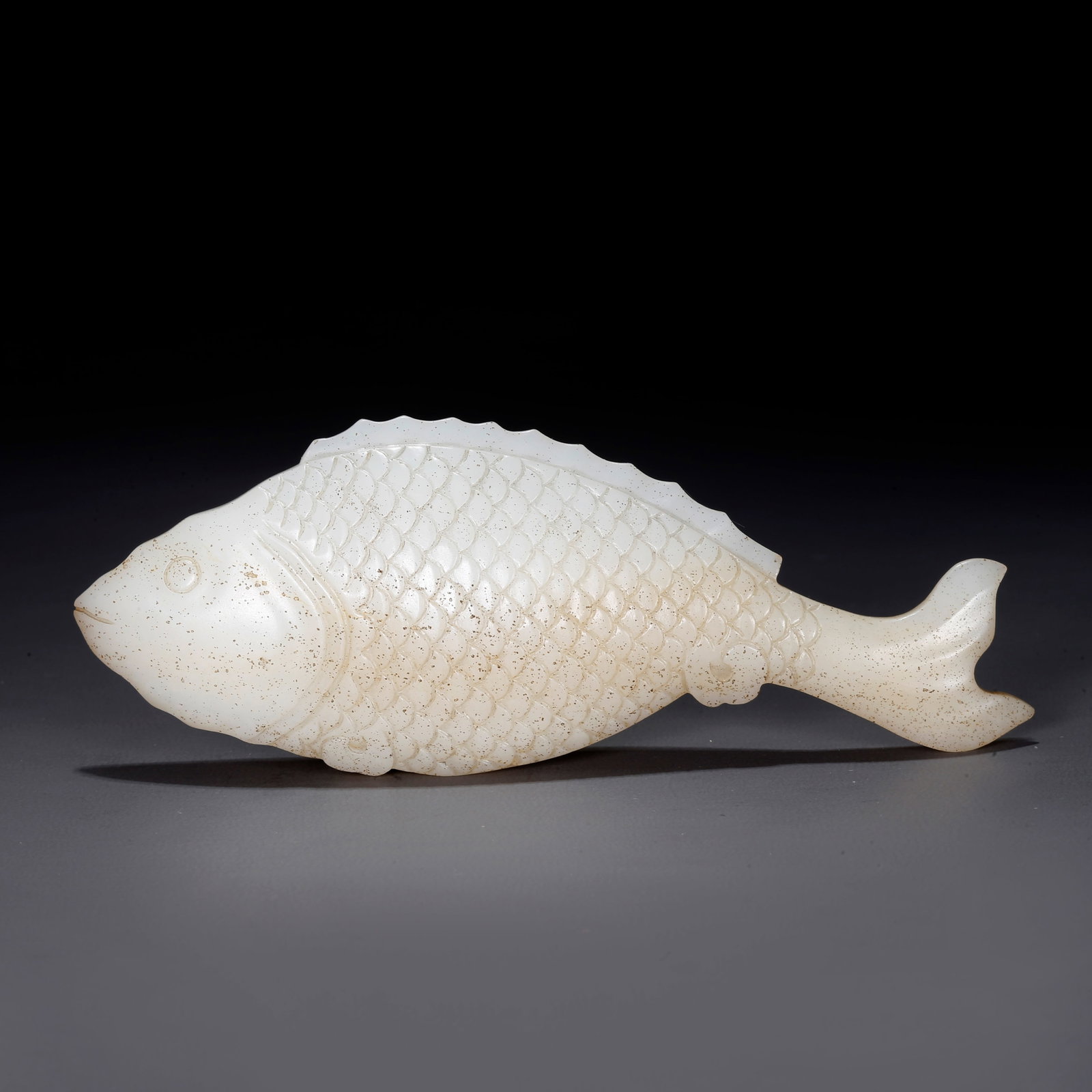 A CARVED HETIAN JADE FISH-SHAPED ORNAMENT: Carved Hetian Jade Fish-shaped Ornament
