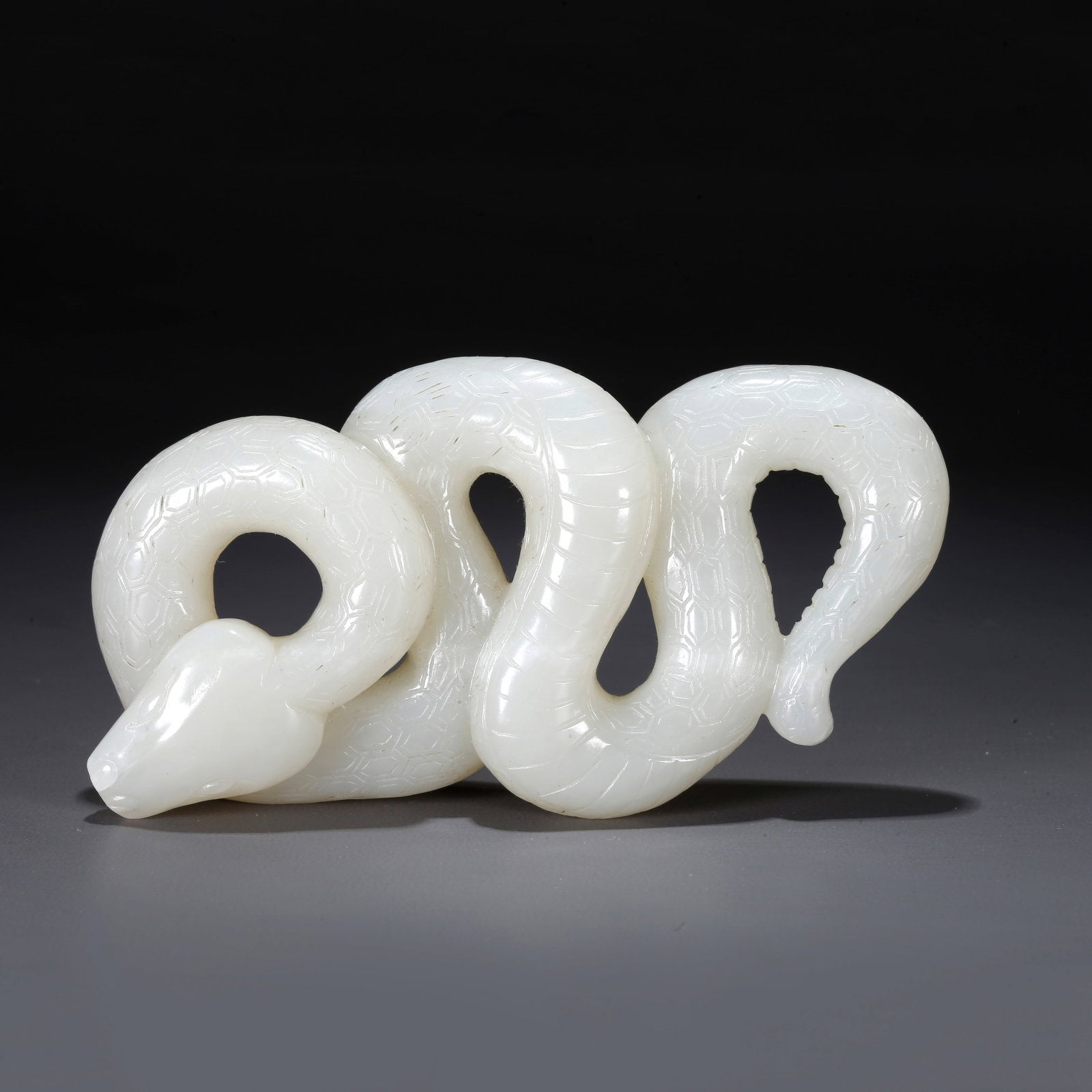 A CARVED HETIAN JADE SNAKE-SHAPED ORNAMENT: Carved Hetian Jade Snake-shaped Ornament