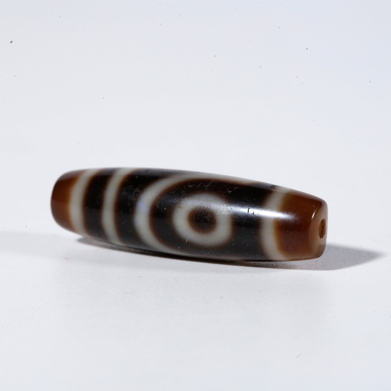 A TWO-EYED DZI BEAD (1 of 9)