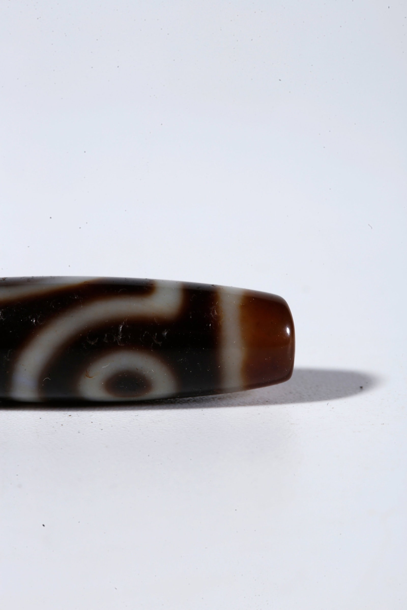 A TWO-EYED DZI BEAD - 7
