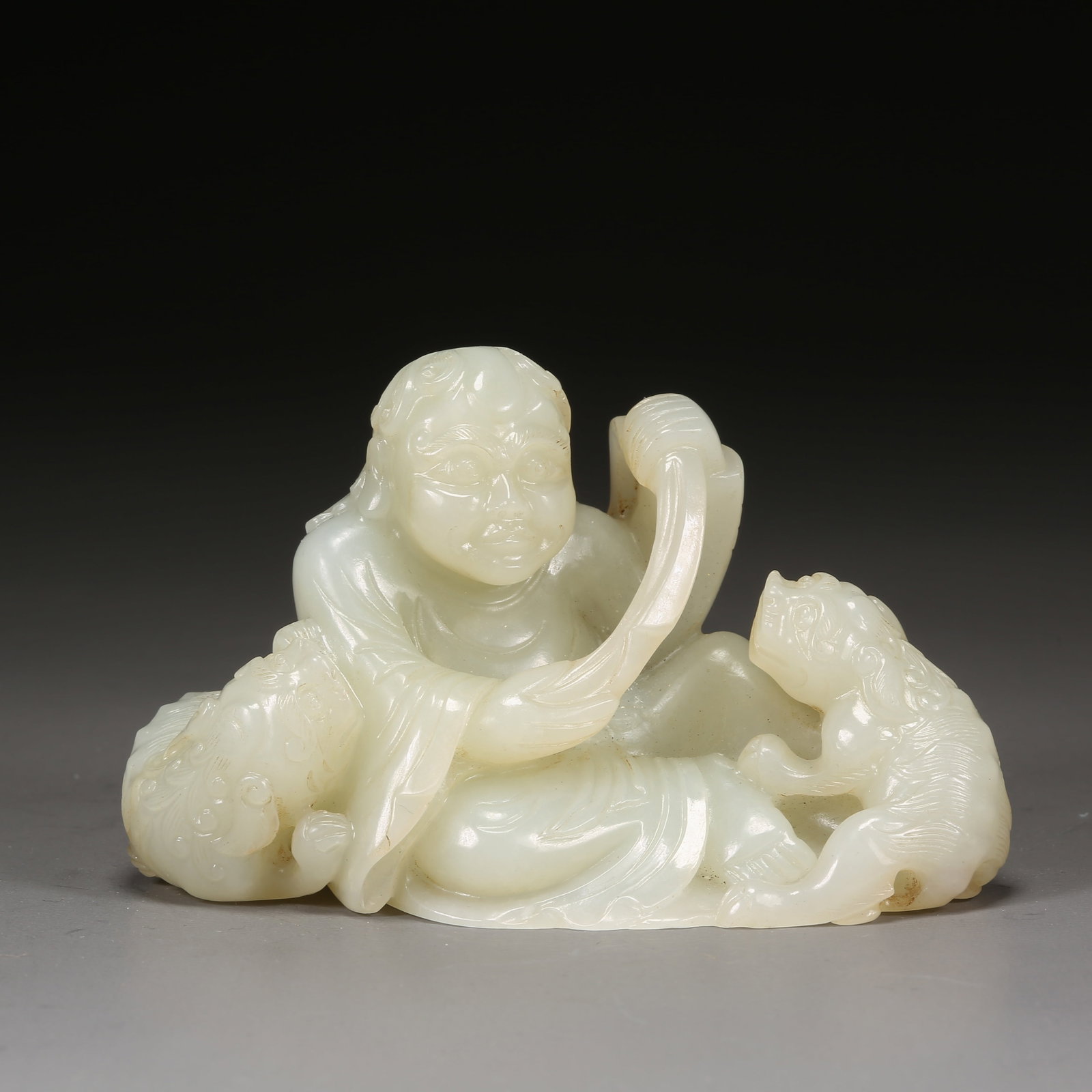 A HETIAN JADE LION-PLAYING ARHAT ORNAMENT (1 of 8)