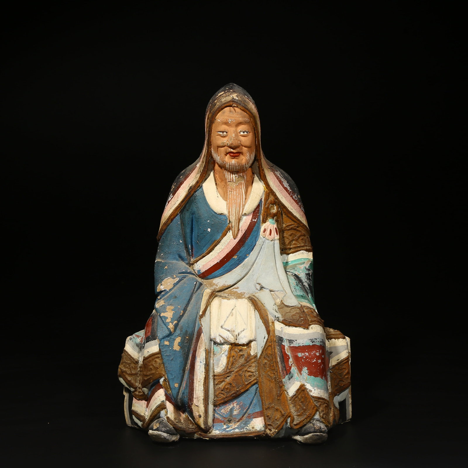 A POLYCHROME PAINTED CLAY FIGURE: Polychrome painted clay figure