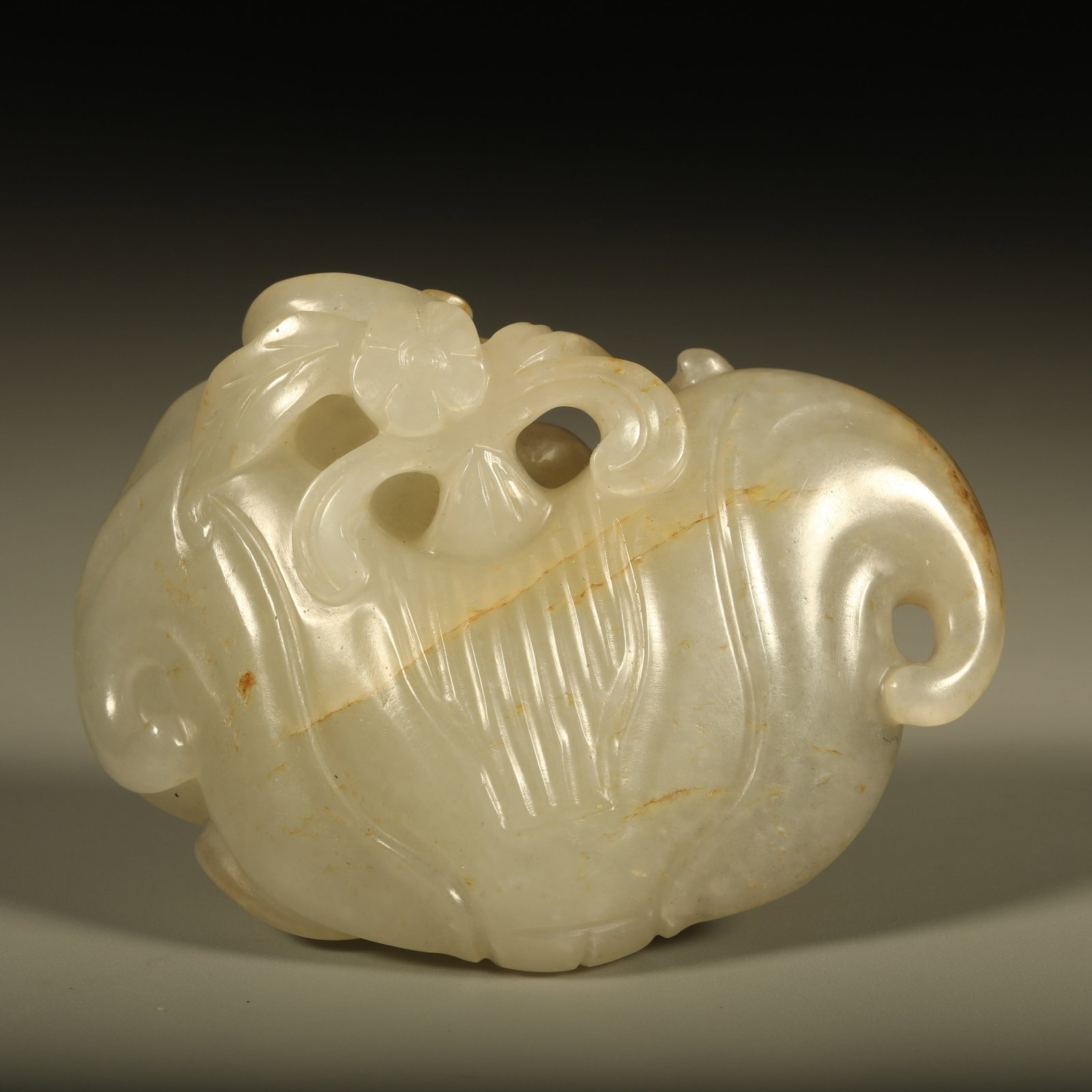 A HETIAN JADE HAND PIECE SHAPED LIKE WATER CHESTNUT: Hetian jade hand piece shaped like water chestnut