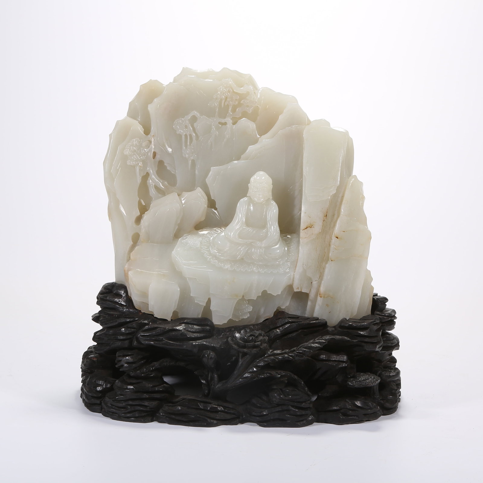 A HETIAN WHITE JADE BUDDHA FIGURINE ON MOUNTAIN-STYLE BASE (1 of 9)