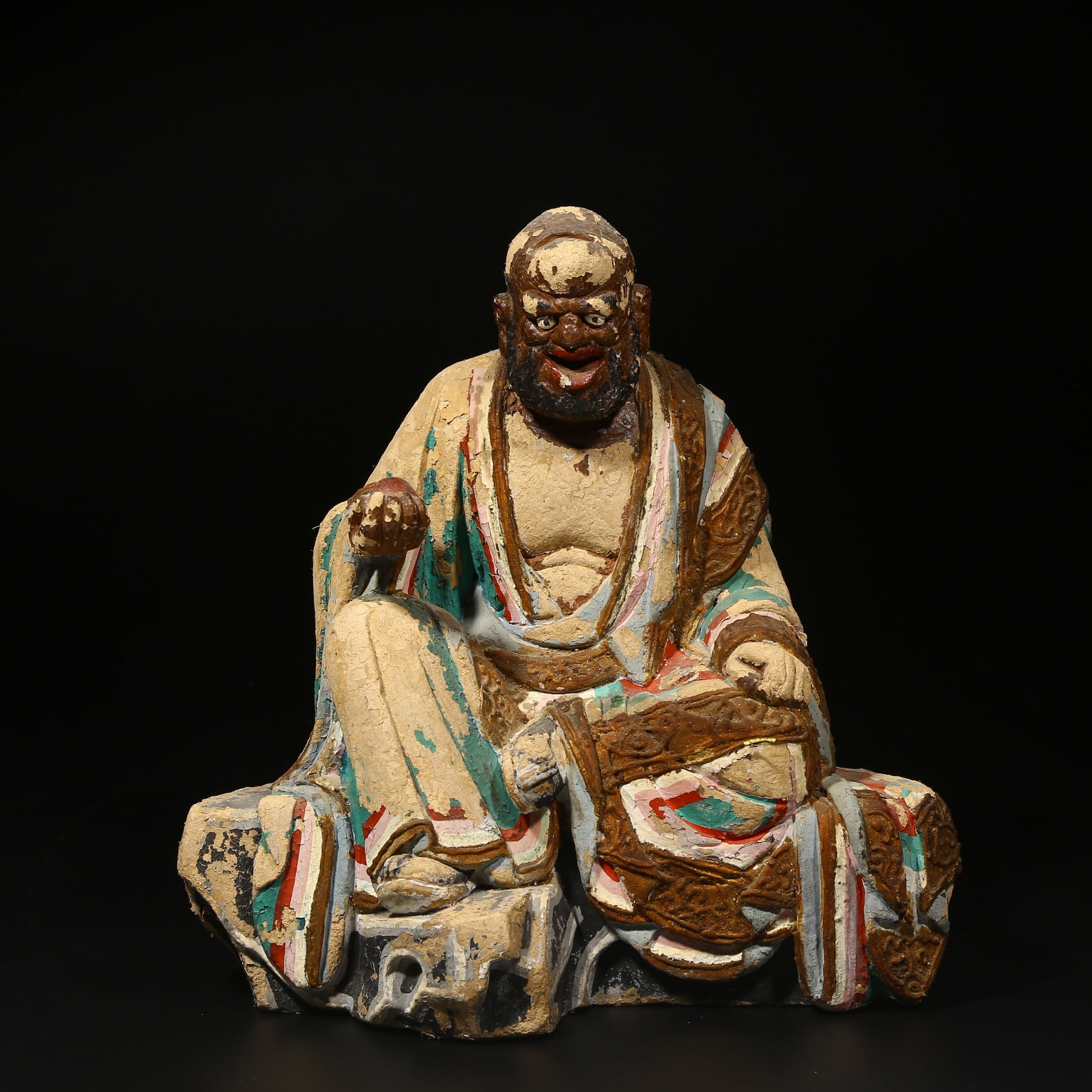A POLYCHROME PAINTED CLAY SCULPTURE OF AN ARHAT: Polychrome painted clay sculpture of an Arhat