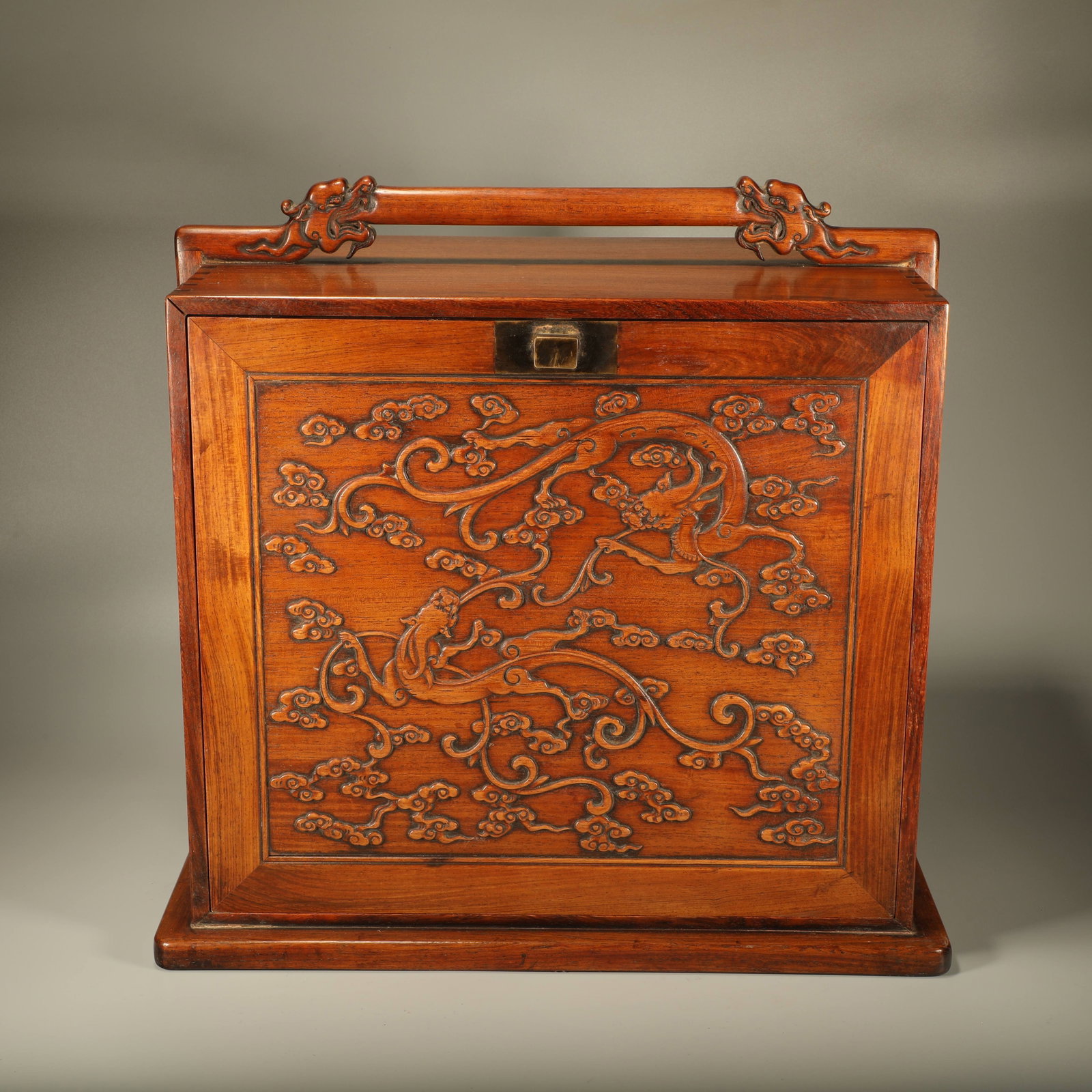 A HUANGHUALI SUITCASE CARVED WITH DRAGON PATTERNS: Huanghuali suitcase carved with dragon patterns