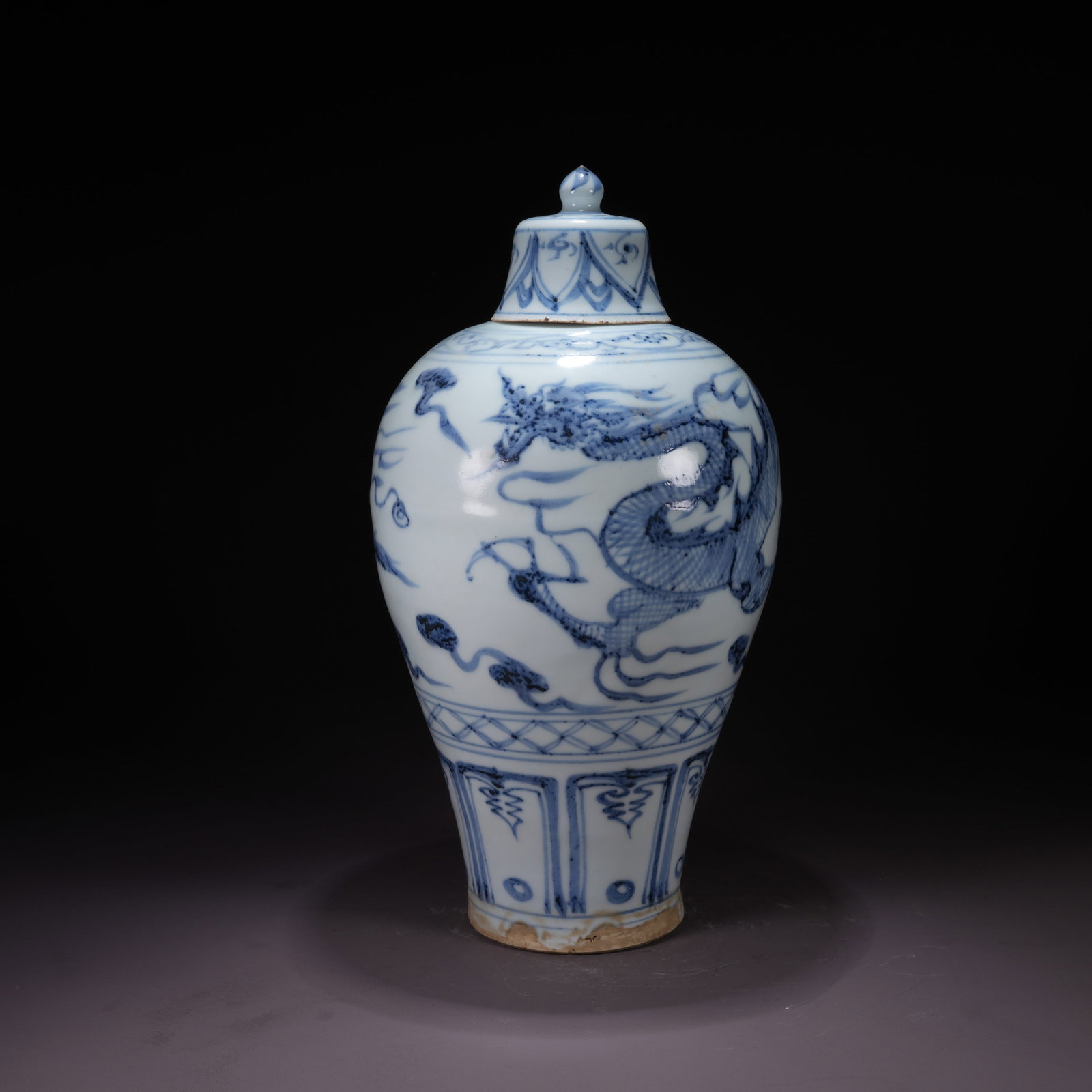 A BLUE-AND-WHITE COVERED VASE WITH CLOUD AND DRAGON MOTIF: Blue-and-White Covered Vase with Cloud and Dragon Motif