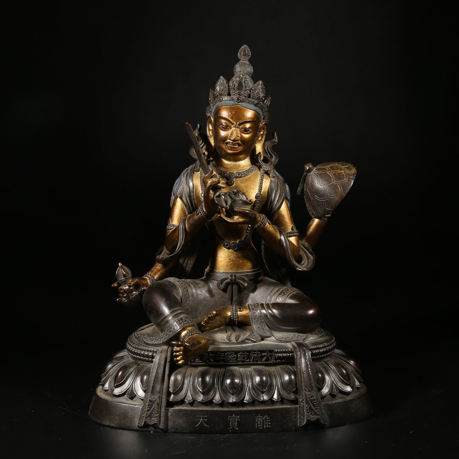 A BRONZE MUD-GILDED STATUE OF L?LAV?HANA (TREASURE DEITY): Bronze Mud-Gilded Statue of Lilavahana (Treasure Deity)
