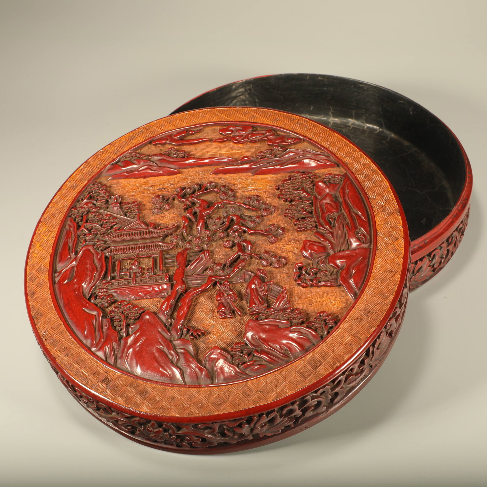 A LACQUERED LIDDED BOX CARVED WITH LANDSCAPE AND FIGURES (1 of 6)