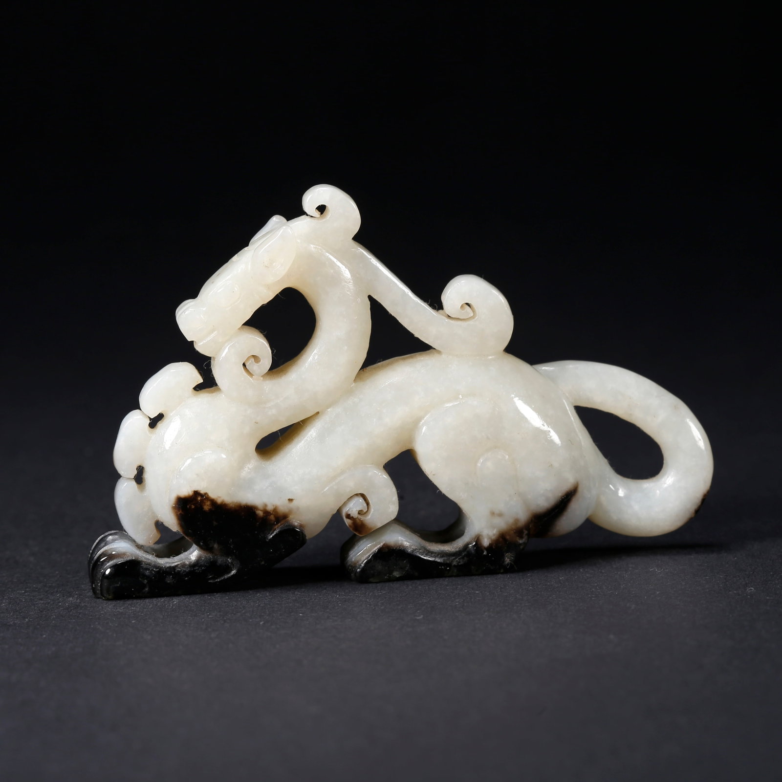 A HETIAN JADE BEAST-SHAPED FIGURINE: Hetian Jade Beast-Shaped Figurine